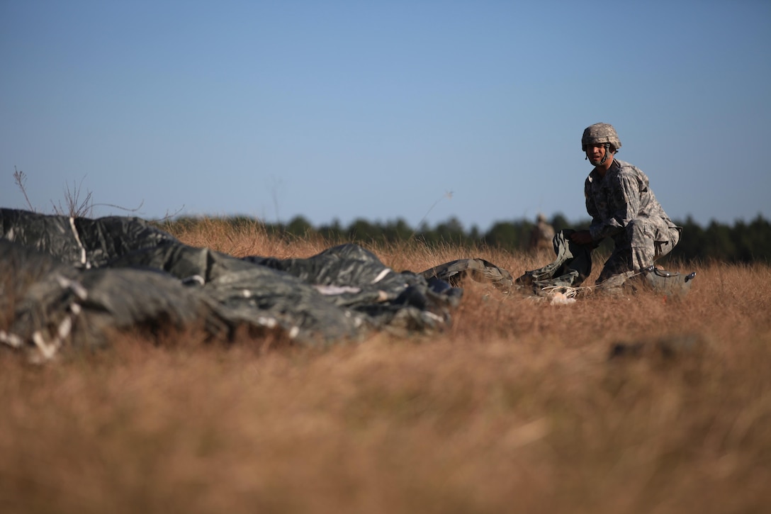 A paratrooper recovers his parachute at the Sicily Drop Zone during training on Fort Bragg, N.C., Nov. 21, 2015. U.S. Army photo by Spc. Darius D. Davis