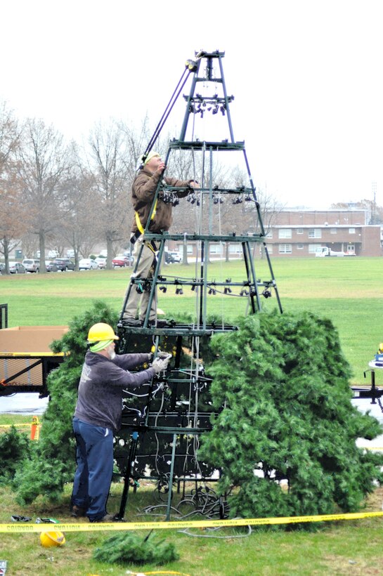 Rodger Boutchyard and Dustin Pritchett, Marine Corps Community Service Buildings and Grounds employees, work to install the holiday tree in front of Lejeune Hall aboard Marine Corps Base Quantico, Nov. 30.