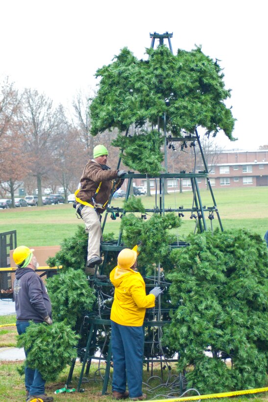 Marine Corps Community Service Buildings and Grounds employees work to install a 25-foot holiday tree in front of Lejeune Hall aboard Marine Corps Base Quantico, Nov. 30. The tree lighting festival will be held Dec. 6 at 4 p.m.