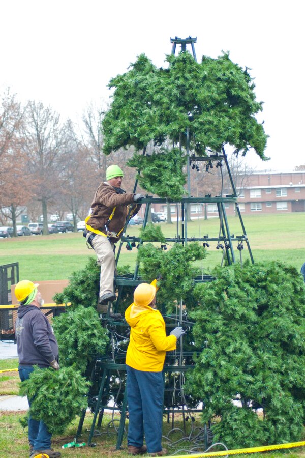 Marine Corps Community Service Buildings and Grounds employees work to install a 25-foot holiday tree in front of Lejeune Hall aboard Marine Corps Base Quantico, Nov. 30. The tree lighting festival will be held Dec. 6 at 4 p.m.