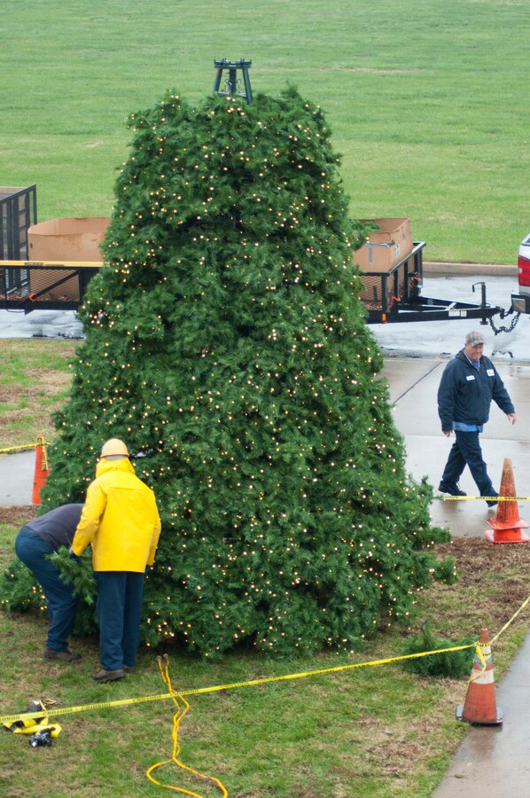Marine Corps Community Service Buildings and Grounds employees work to install a 25-foot holiday tree in front of Lejeune Hall aboard Marine Corps Base Quantico, Nov. 30. The tree lighting festival will be held Dec. 6 at 4 p.m.