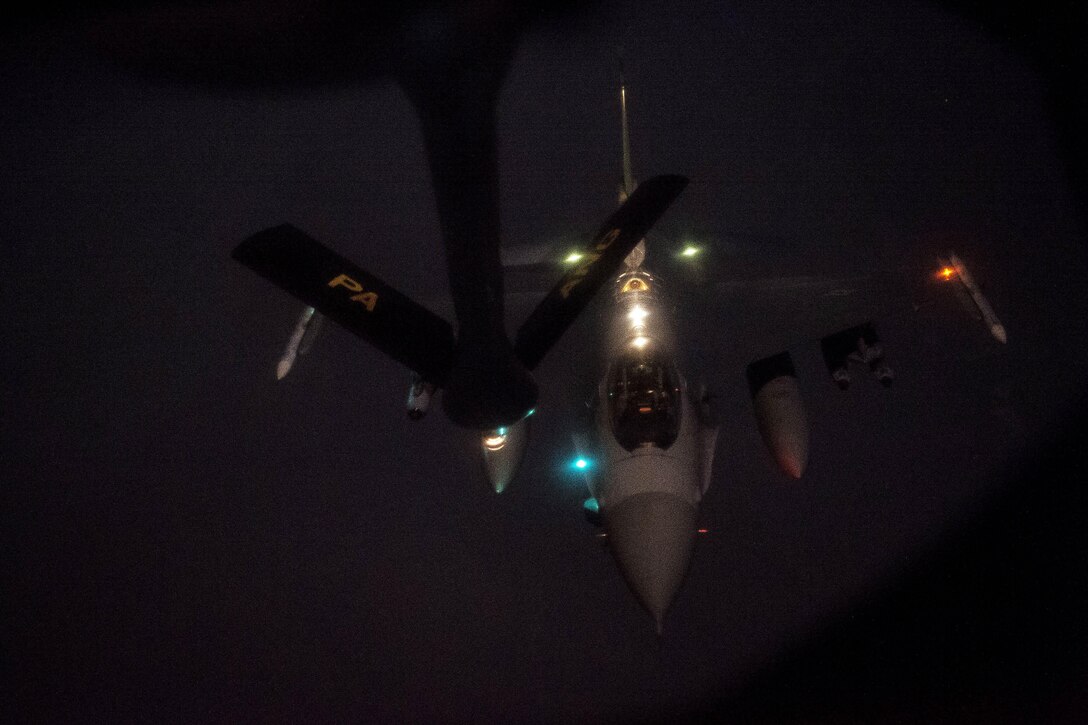 A U.S. Air Force F-16 Fighting Falcon flies into position to receive fuel from a KC-135T Stratotanker in support of Operation Inherent Resolve over Southwest Asia, Nov. 24, 2015. U.S. Air Force photo by Staff Sgt. Corey Hook