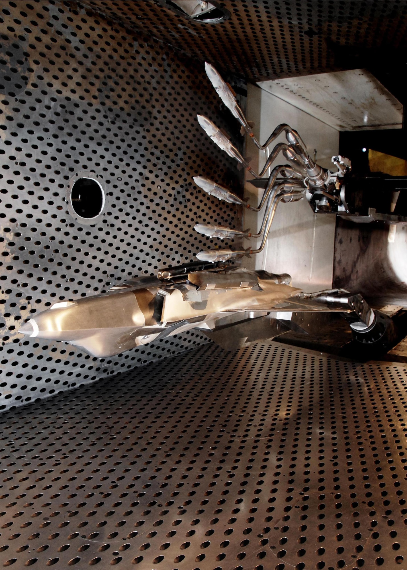 Initial weapon integration testing for the F-35 was conducted at the Arnold Engineering Development Complex. Pictured here are multiple exposures of a Guided Bomb Unit-31 Joint Direct Attack Munition, separating from the F-35 Lightning II aircraft in the 4-foot transonic wind tunnel during testing at AEDC in 2007. (Courtesy photo/Rick Goodfriend)