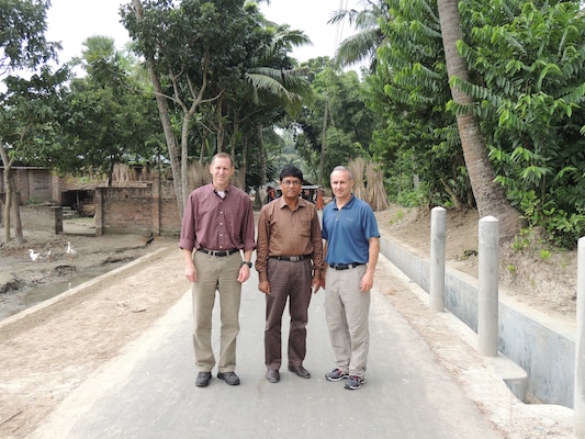 From left to right, Randy Bowker, chief of Programs and Project Management Division, U.S. Army Corps of Engineers-Alaska District; Md. Abu Shahriar, Local Government Engineering Department of Bangladesh district engineer for the Jessore District; and Col. Michael Brooks, commander of the U.S. Army Corps of Engineers-Alaska District, pose for a picture in early October after examining one of eight recently constructed roads in Jessore, Bangladesh. The Alaska District, in collaboration with the U.S. Agency for International Development and the Local Government Engineering Department of Bangladesh, completed the roads in the first government-to-government agreement in the country. The roads are instrumental in helping local farmers get their crops to the market, children get to school easier and facilitating families’ access to medical clinics, thus increasing the quality of life for the people of the region.