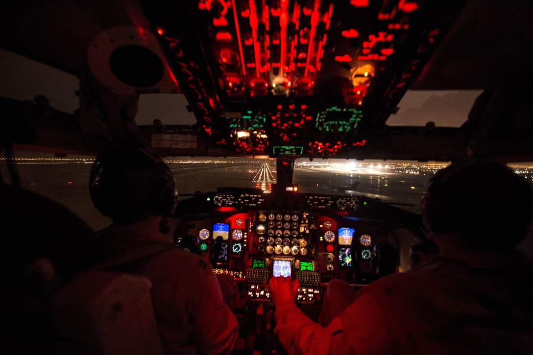 U.S. Air Force Capt. Mark Costa, left, and U.S. Air Force Maj. Joseph Corpening land a KC-135T Stratotanker after conducting a mission to support Operation Inherent Resolve over Southwest Asia, Nov. 24, 2015. Costa and Corpening are pilots assigned to the 340th Expeditionary Air Refueling Squadron. U.S. Air Force photo by Staff Sgt. Corey Hook