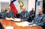 Rear Adm. Rebecca McCormick-Boyle (left), commander, Navy  Medicine Education and Training Command, gives Force Master Chief Terry Prince (second from right), Navy Medicine, a command brief. Prince visited different Navy Medicine commands in San  Antonio to talk to leaders and Sailors Nov. 16-18.