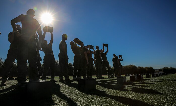 Recruits of Lima Company, 3rd Recruit Training Battalion, execute the ammunition can lift during the Combat Fitness Test at Marine Corps Recruit Depot San Diego, Dec. 2. The ammunition cans weigh 30 pounds and were used to conduct overhead presses. Each recruit performed as many presses as he could in two minutes, attempting to reach 91 repetitions to achieve a perfect score. Today, all males recruited from west of the Mississippi are trained at MCRD San Diego. The depot is responsible for training more than 16,000 recruits annually. Lima Company is scheduled to graduate Feb. 5.