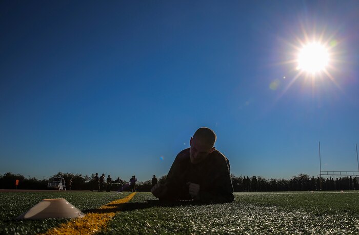 A recruit of Lima Company, 3rd Recruit Training Battalion, low crawls for 10 yards during the Combat Fitness Test at Marine Corps Recruit Depot San Diego, Dec. 2. The final event of the CFT was the maneuver under fire. The course for this portion covers 75 yards and requires recruits to perform exercises such as sprints, ammunition can carries, fireman’s carry and throwing a simulated grenade at a marked target. Recruits were timed as they ran through the course and needed to finish it in less than 2 minutes and 14 seconds to receive 100 points. Today, all males recruited from west of the Mississippi are trained at MCRD San Diego. The depot is responsible for training more than 16,000 recruits annually. Lima Company is scheduled to graduate Feb. 5.