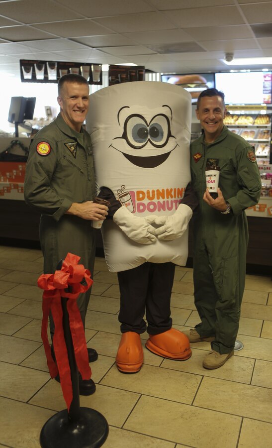 Maj. Gen. Michael Rocco, commanding general of the 3rd Marine Aircraft Wing, and Col. Jason Woodworth, commanding officer of Marine Corps Air Station Miramar, pose with “Cuppy,” the Dunkin’ Donuts mascot, at the grand opening of Dunkin' Donuts aboard MCAS Miramar, Calif., Dec. 2. Rocco and Woodworth participated in the ribbon cutting ceremony for the new establishment.