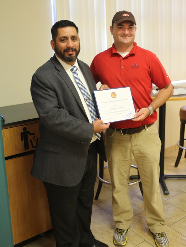 Dunkin’ Donuts associates accept a Certificate of Special Congressional Recognition aboard Marine Corps Air Station Miramar, Calif., Dec. 2. Dunkin’ Donuts received the certificate at its grand opening.