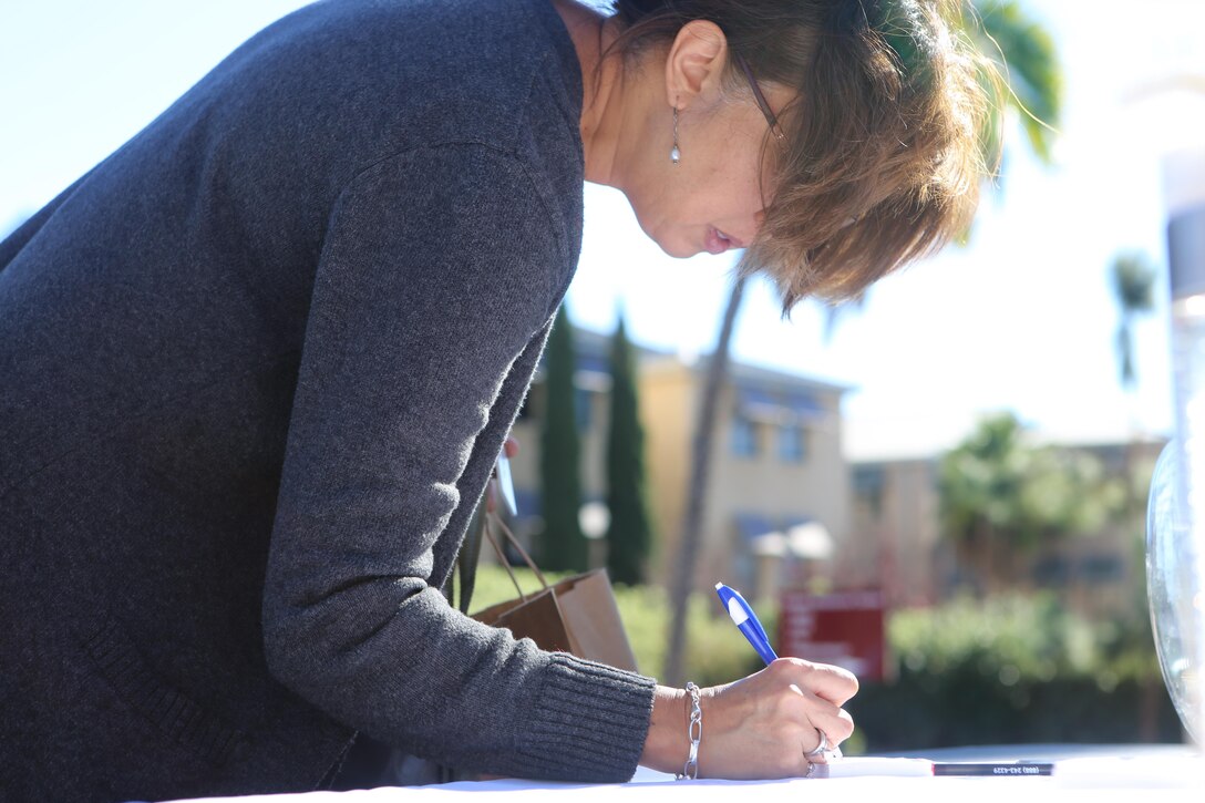 A civilian signs up for a raffle at the grand opening of Dunkin’ Donuts aboard Marine Corps Air Station Miramar, Calif., Dec. 2. Following a ribbon cutting ceremony, the new establishment received a Certificate of Special Congressional Recognition.