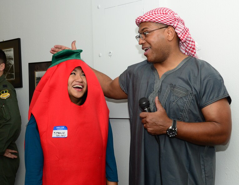 Major General Richard Clark, Eighth Air Force commander and Festivus host, congratulates Airman 1st Class Krystal Cleary, 608th Air Operations Center offensive duty technician, on her 21st birthday during the Mighty Eighth Festivus celebration at Barksdale Air Force Base, La., Dec. 2, 2015. After the celebration, a contest was held to determine who had the best booth, and the winner received a leg-lamp as a trophy. (U.S. Air Force photo/Senior Airman Benjamin Raughton)