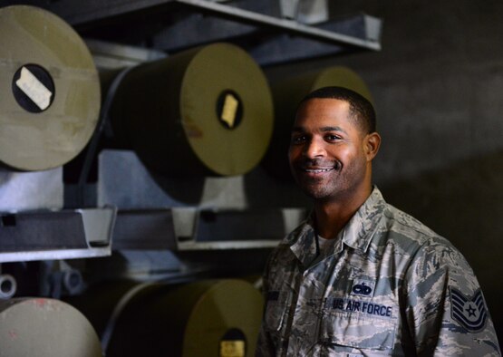 Tech. Sgt. Dan Edwards, 51st Munitions Squadron storage shift lead, poses in front of munition pallets stacked high at Osan Air Base, Republic of Korea, Nov. 17, 2015. MUNS Airmen are responsible for building, storing, maintaining, inspecting and delivering everything from 2,000 pound bombs to 9mm rounds. 
(U.S. Air Force photo/Staff Sgt. Amber Grimm)