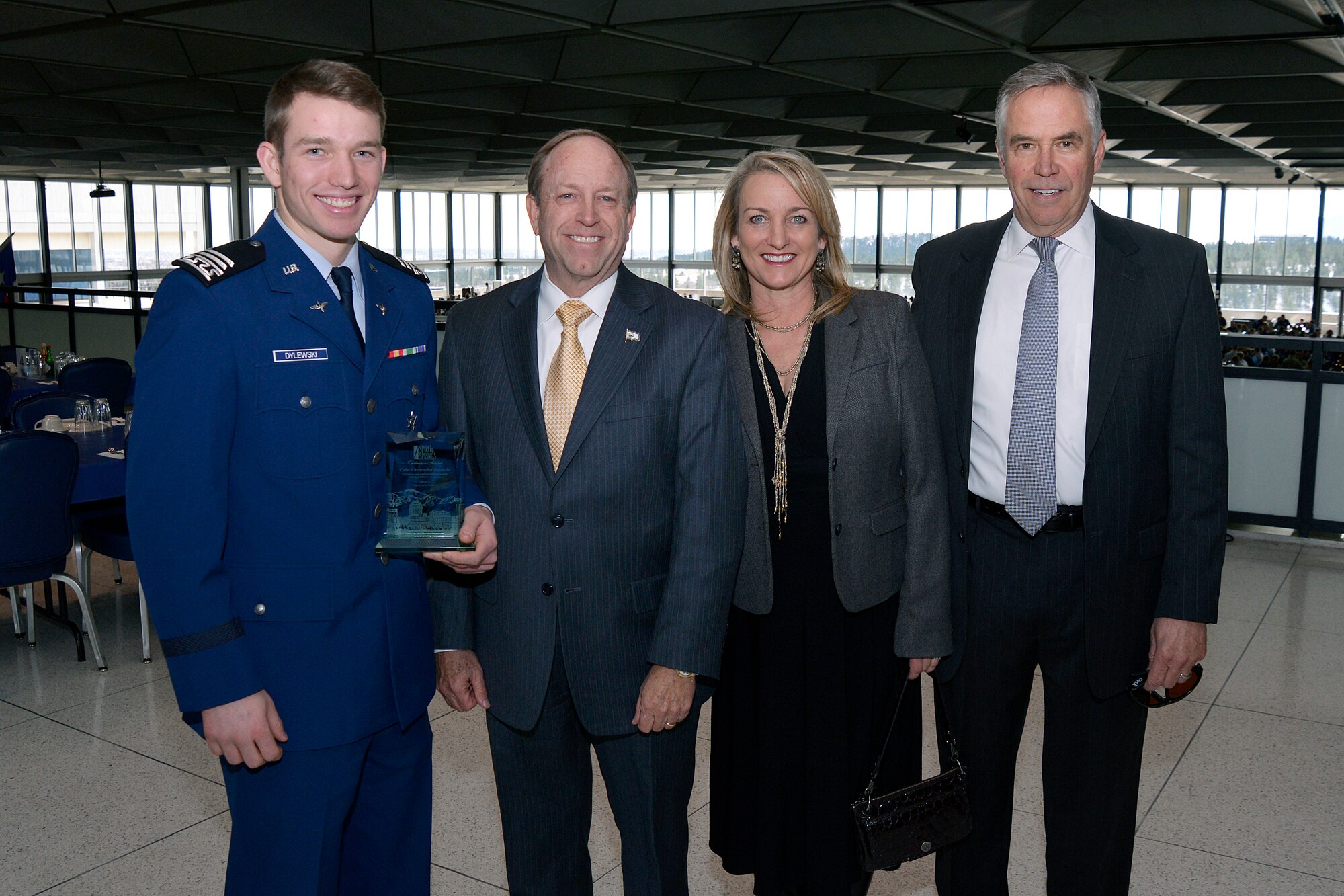 Cadet 1st Class Christopher Dylewski (left) poses for a photograph with Colorado Springs Mayor John Suthers; his father, retired Maj. Gen. Gary Dylewski; and mother, Lynne Dylewski, at the Air Force Academy's Staff Tower Dec. 1. Suthers presented Dylewski with the Spirit of the Springs Award for his longstanding community support. (U.S. Air Force photo/Jason Gutierrez)  