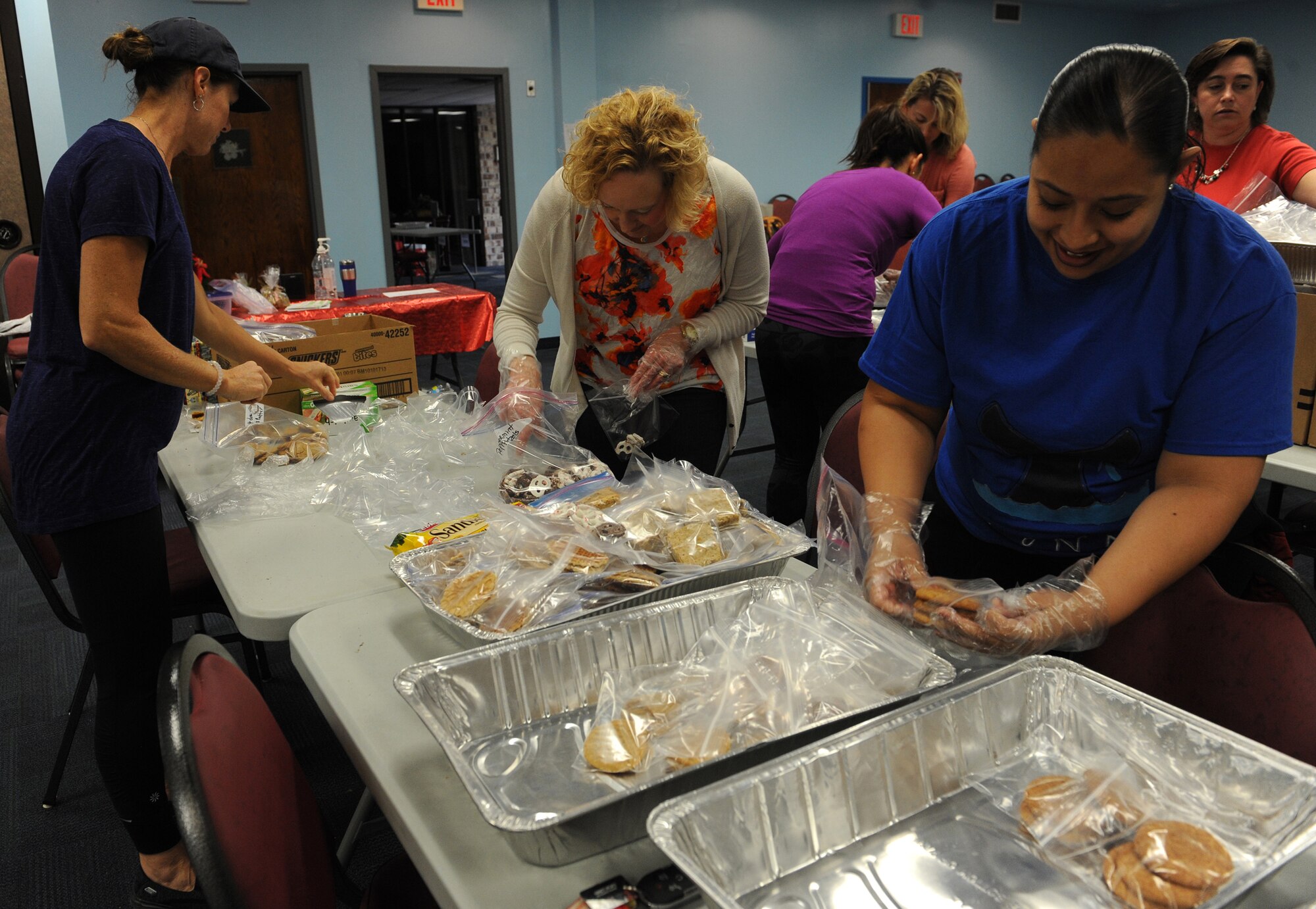 Moody Spouses Club sort cookies before placing them in bags during the Annual Airmen’s Cookie Drive, Dec. 2, 2015, at Moody Air Force Base, Ga. The volunteers packed each bag with 15 to 20 cookies for Airmen living in the dorms. (U.S. Air Force photo by Airman 1st Class Kathleen D. Bryant/Released)
