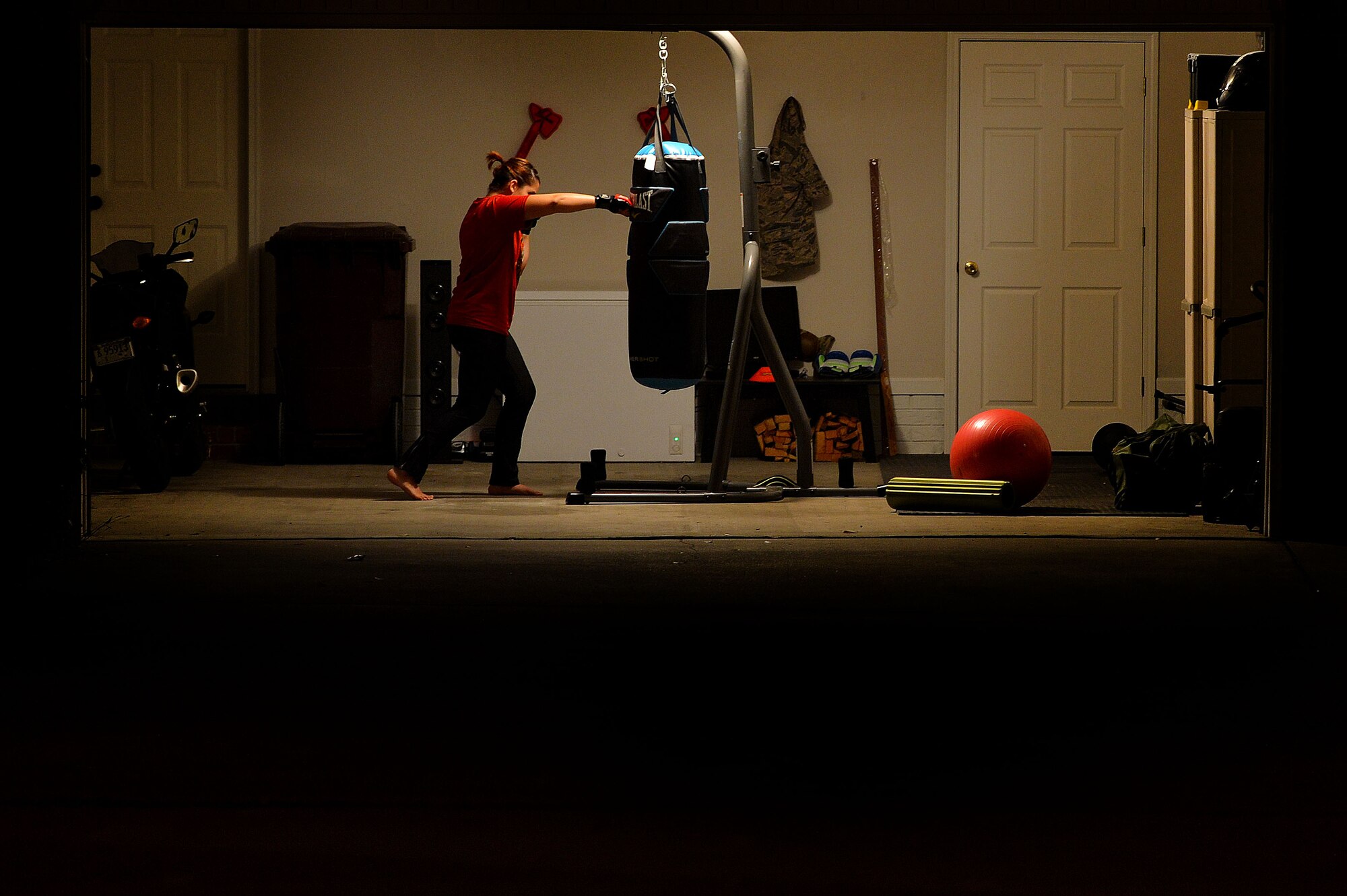 U.S. Air Force Senior Airman Diana Cossaboom, 20th Fighter Wing Public Affairs photojournalist, punches a training bag in Sumter, S.C., Nov. 19, 2015. Cossaboom trained in multiple types of martial arts including jiu-jitsu, kudo, and mixed martial arts. (U.S. Air Force photo by Senior Airman Michael Cossaboom)
