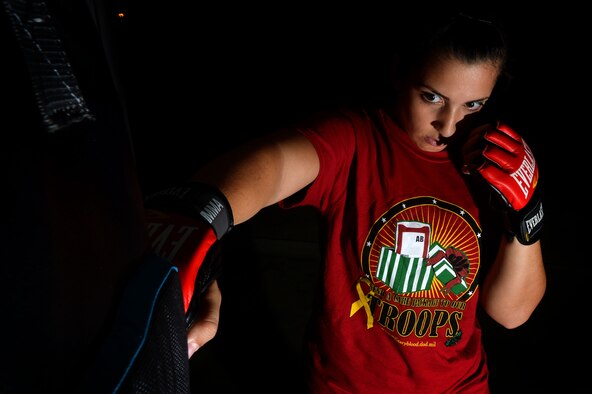 U.S. Air Force Senior Airman Diana Cossaboom, 20th Fighter Wing Public Affairs photojournalist, punches a training bag in Sumter, S.C., Nov. 19, 2015. Cossaboom started training in martial arts when she was 4 years old. (U.S. Air Force photo by Senior Airman Michael Cossaboom)