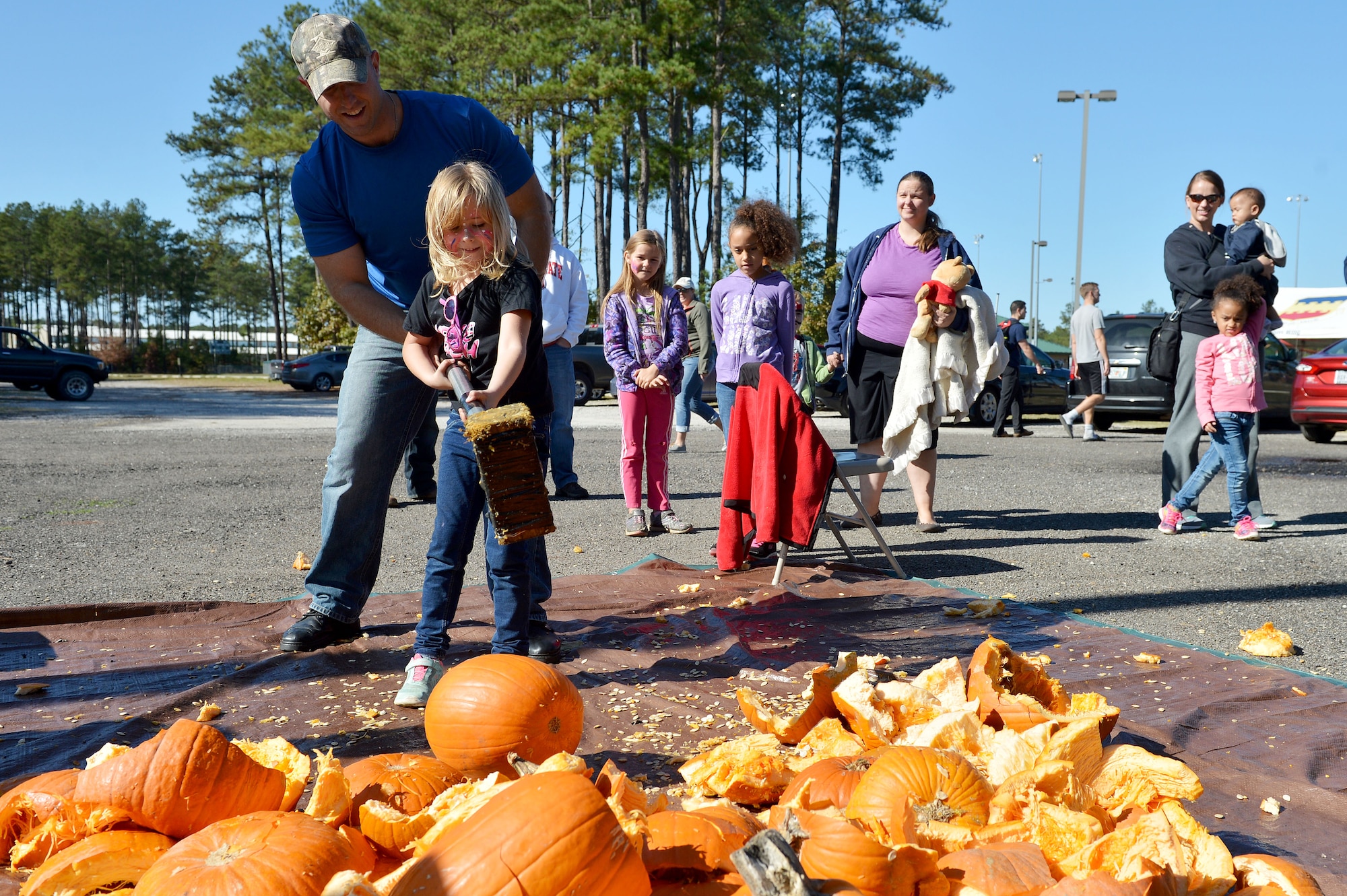 Two Team Shaw members smash a pumpkin during a Fall Family Picnic event at Shaw Air Force Base, S.C., Nov. 21, 2015. Approximately 400 Team Shaw members attended the event which offered face painting, pumpkin smashing, pumpkin painting, inflatables, sumo wrestling, and pugil stick fighting. (U.S. Air Force photo by Senior Airman Diana M. Cossaboom)