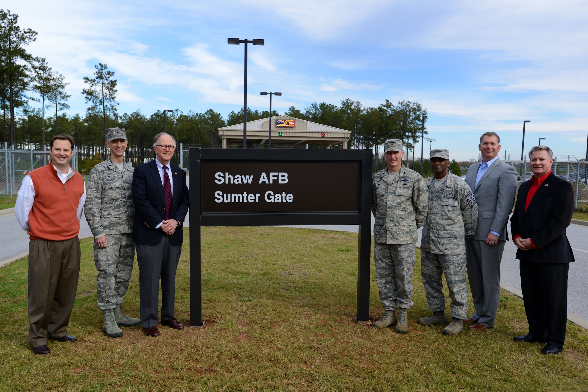 Team Shaw leadership, along with representatives from the city of Sumter, stand with the new sign in front of the Sumter Gate at Shaw Air Force Base, S.C., Dec. 3, 2015. The Sumter Gate, previously the ‘East Gate’, was renamed because of its proximity to the city. (U.S. Air Force photo by Airman 1st Class Kelsey Tucker)