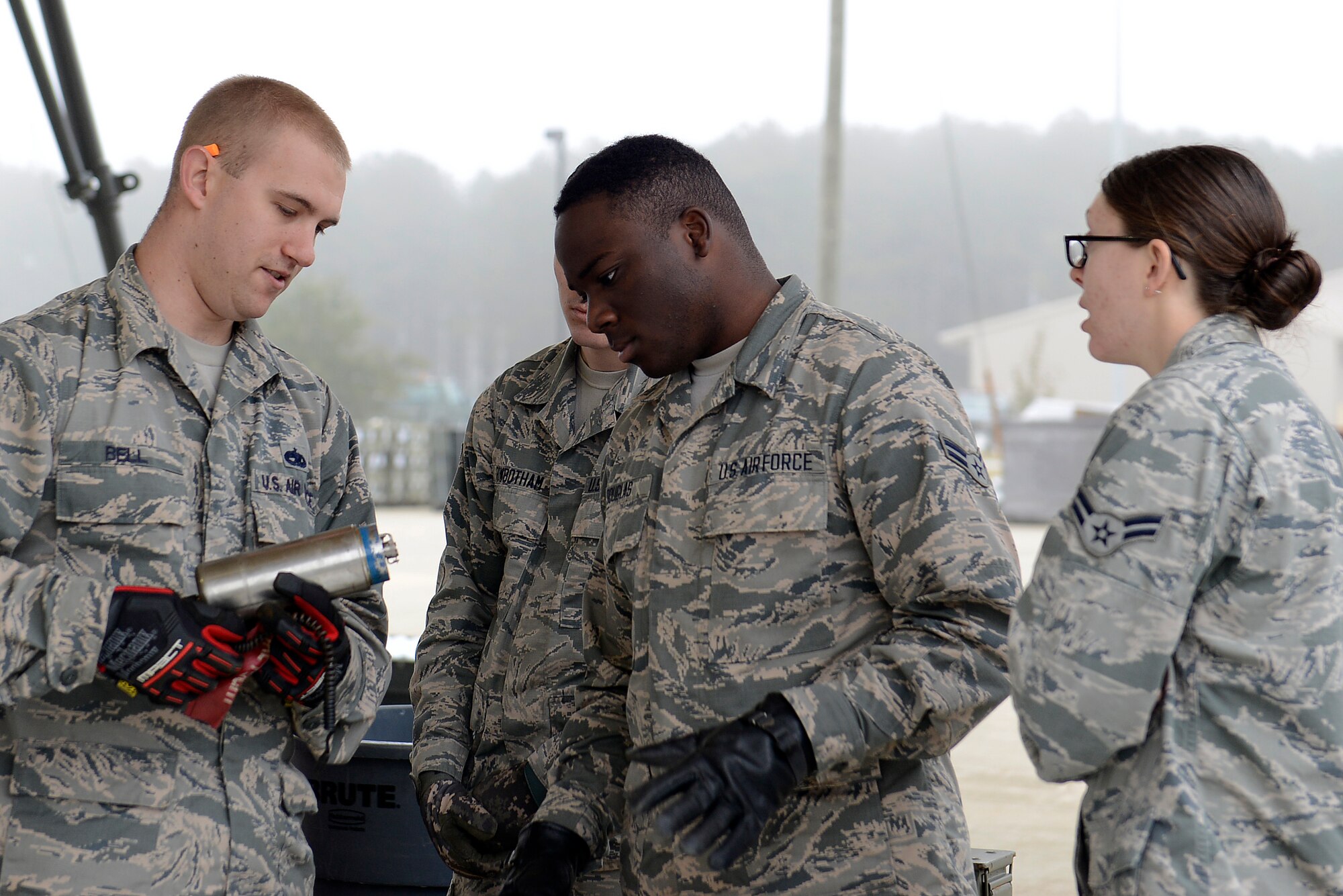 A 20th Equipment Maintenance Squadron Airman shows an inert guided bomb unit fuse during an Ammo assembly demonstration at Shaw Air Force Base, S.C., Dec. 1, 2015. After a safety briefing and instructions on the various pieces of a munition, the non-muntions Airmen acted on what they were taught and built an inert bomb.  (U.S. Air Force photo by Airman 1st Class Christopher Maldonado)