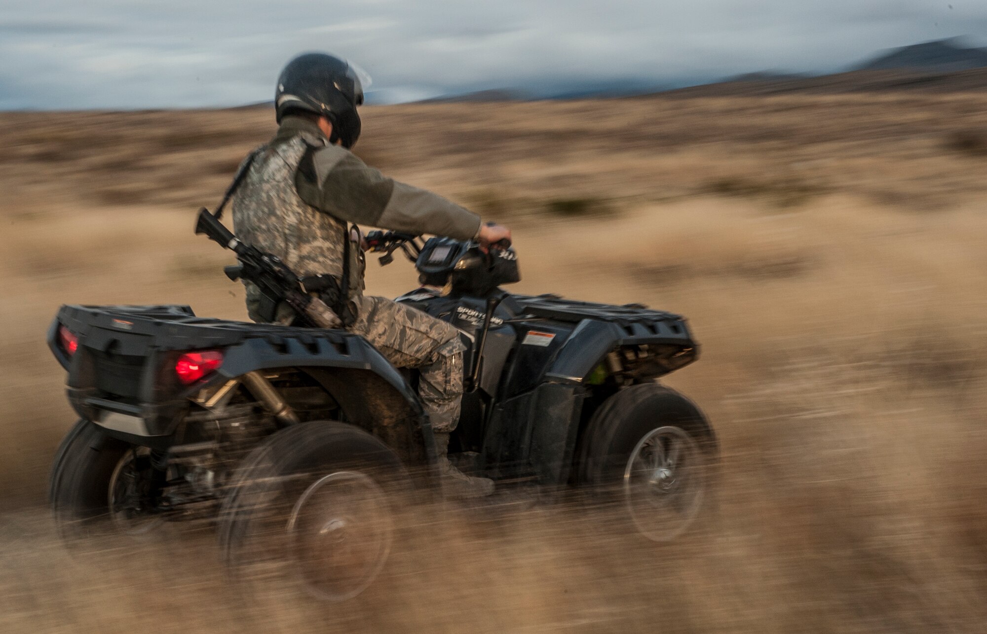 A Security Forces member accelerates through a field, heading back to the entry control point of an F-16 crash site Northwest of Salinas Peak, New Mexico, Nov. 26. Security Forces were responsible for security, parking and tracking the ECP to ensure that no unauthorized personnel entered the crash scene. (U.S. Air Force photo by Airman 1st Class Randahl J. Jenson)   