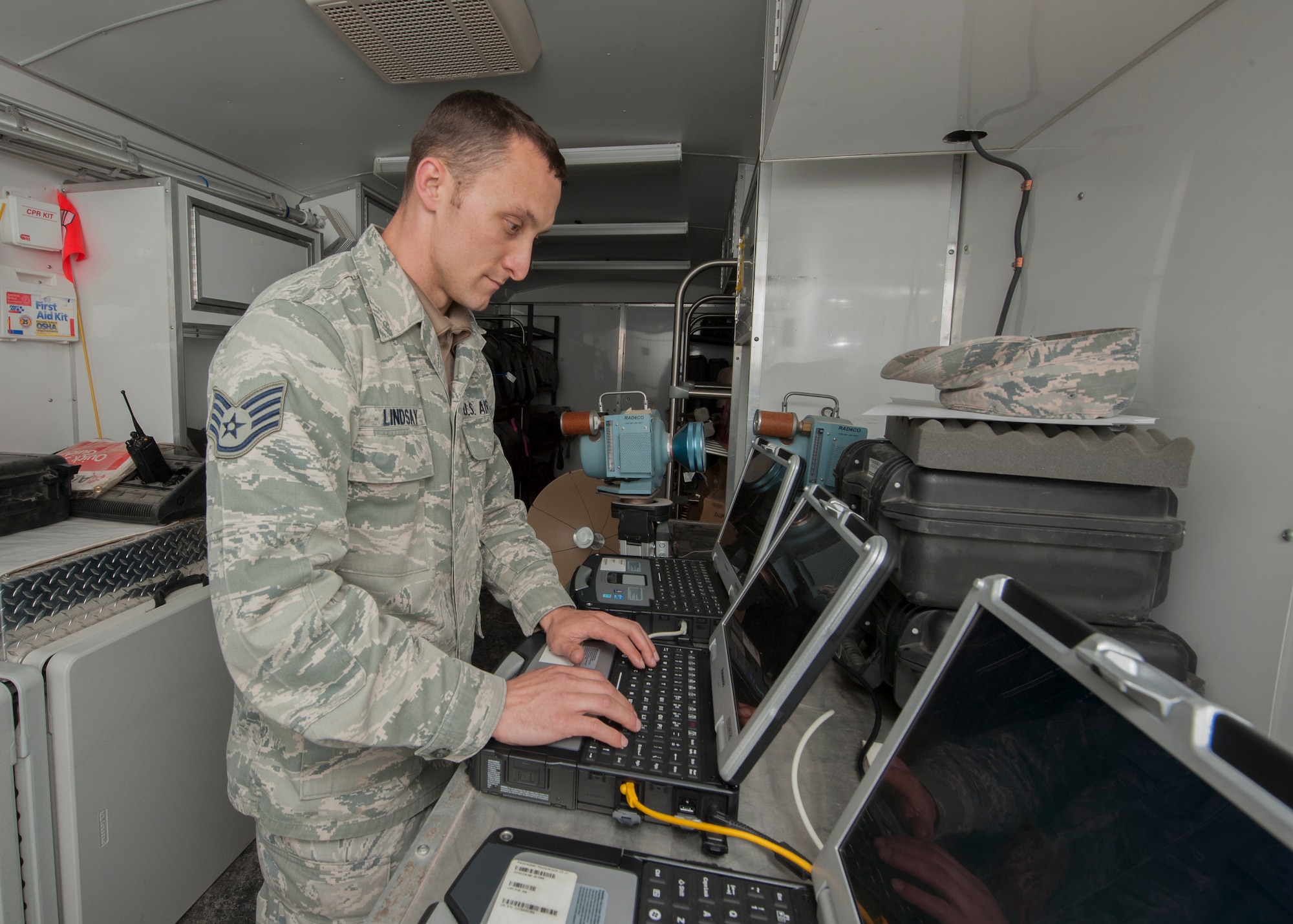 Staff Sgt. Michael Lindsay, a Hammer Adaptive Communication Element operator, starts up a computer inside a communication trailer outside an F-16 crash site northwest of Salinas Peak, New Mexico on Nov. 26. Lindsay and two other Hammer A.C.E. team members flew from Georgia to help Holloman acquire and maintain communications during the crash investigation. (U.S. Air Force photo by Airman 1st Class Randahl J. Jenson)  