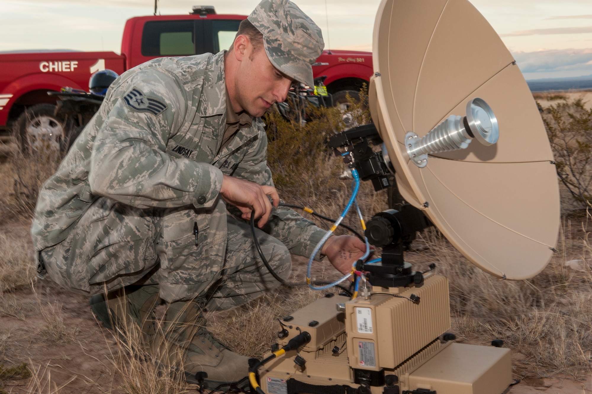 Staff Sgt. Michael Lindsay, a Hammer Adaptive Communication Element operator, disassembles a Panther terminal outside an F-16 crash site northwest of Salinas Peak, New Mexico on Nov. 26. Hammer A.C.E. operatives provide strategic communications for emergencies, both military and humanitarian, worldwide at any time. (U.S. Air Force photo by Airman 1st Class Randahl J. Jenson) 