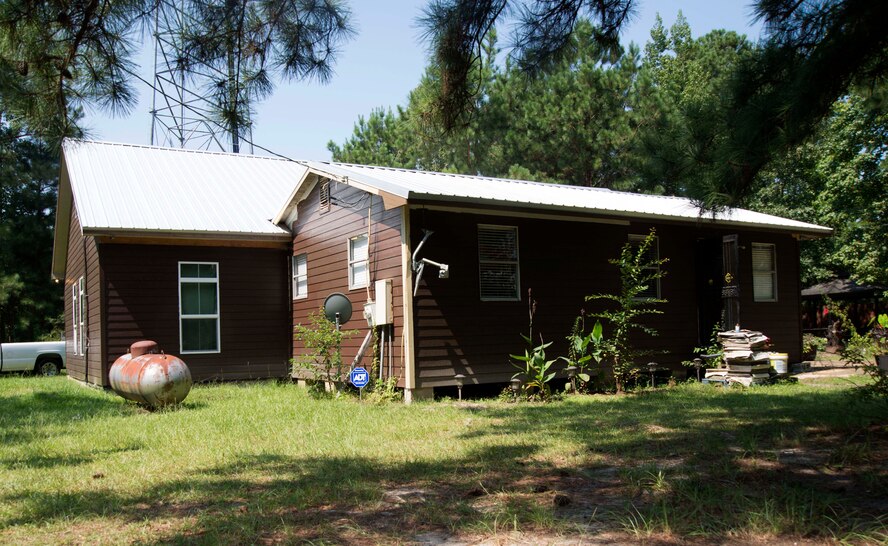 The Hands Off Women battered and homeless women and children’s shelter stays hidden among the woods, Sept. 4, 2015 in Shorter, Ala.  Two Maxwell Airmen,  TSgt Sgt. Johnathan Kirby, and Staff Sgt. Jody Perkins, developers at the Air Force Center for Electronic Distribution and Systems, volunteer their construction skill to get the shelter up and running.  (U.S. Air Force photo by Airman 1st Class Alexa Culbert)