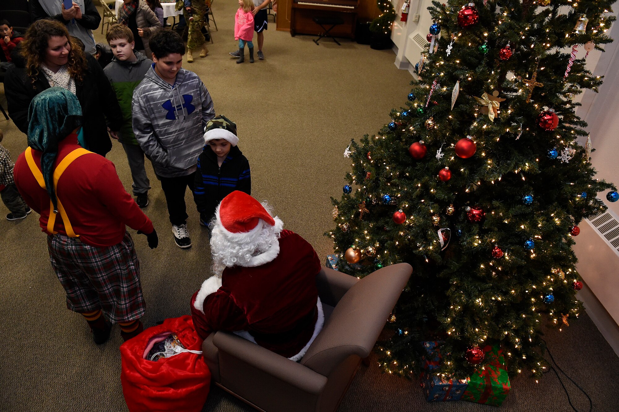 Children line up to talk with Santa during the McChord Field annual Holiday Lighting Ceremony Dec. 2, 2015 at Joint Base Lewis-McChord, Wash. The ceremony marks the kick-off to the 2015 holiday season. (U.S. Air Force photo by Tech. Sgt. Tim Chacon)