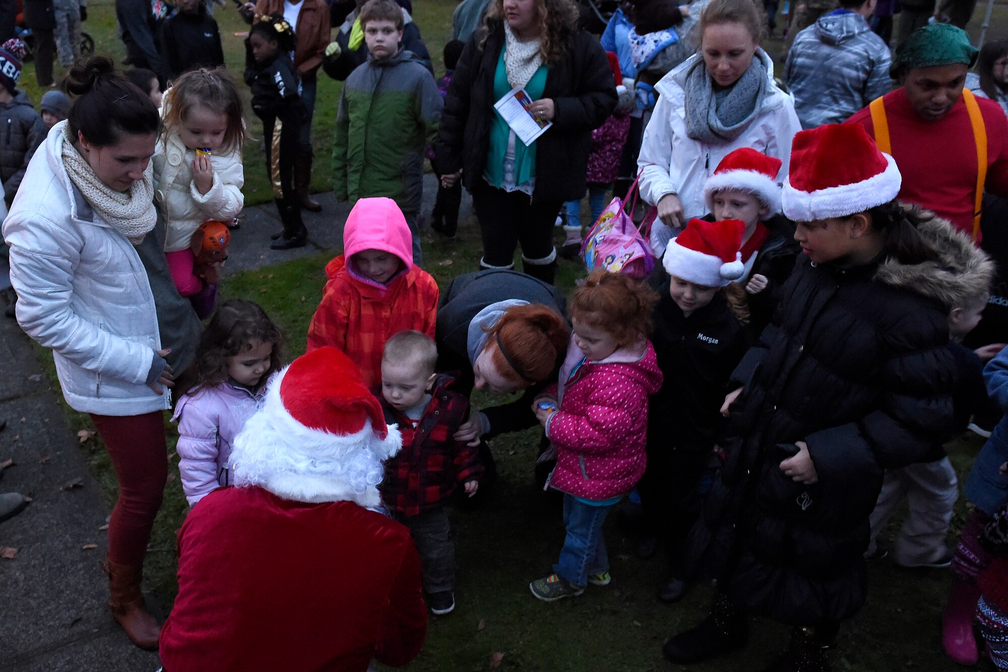 Santa greets children at the McChord Field Annual Holiday Lighting Ceremony Dec. 2, 2015 at Joint Base Lewis-McChord, Wash. Santa handed out candy and later took photos with the children while taking their request for their possible gifts. (U.S. Air Force photo by Tech. Sgt. Tim Chacon)  