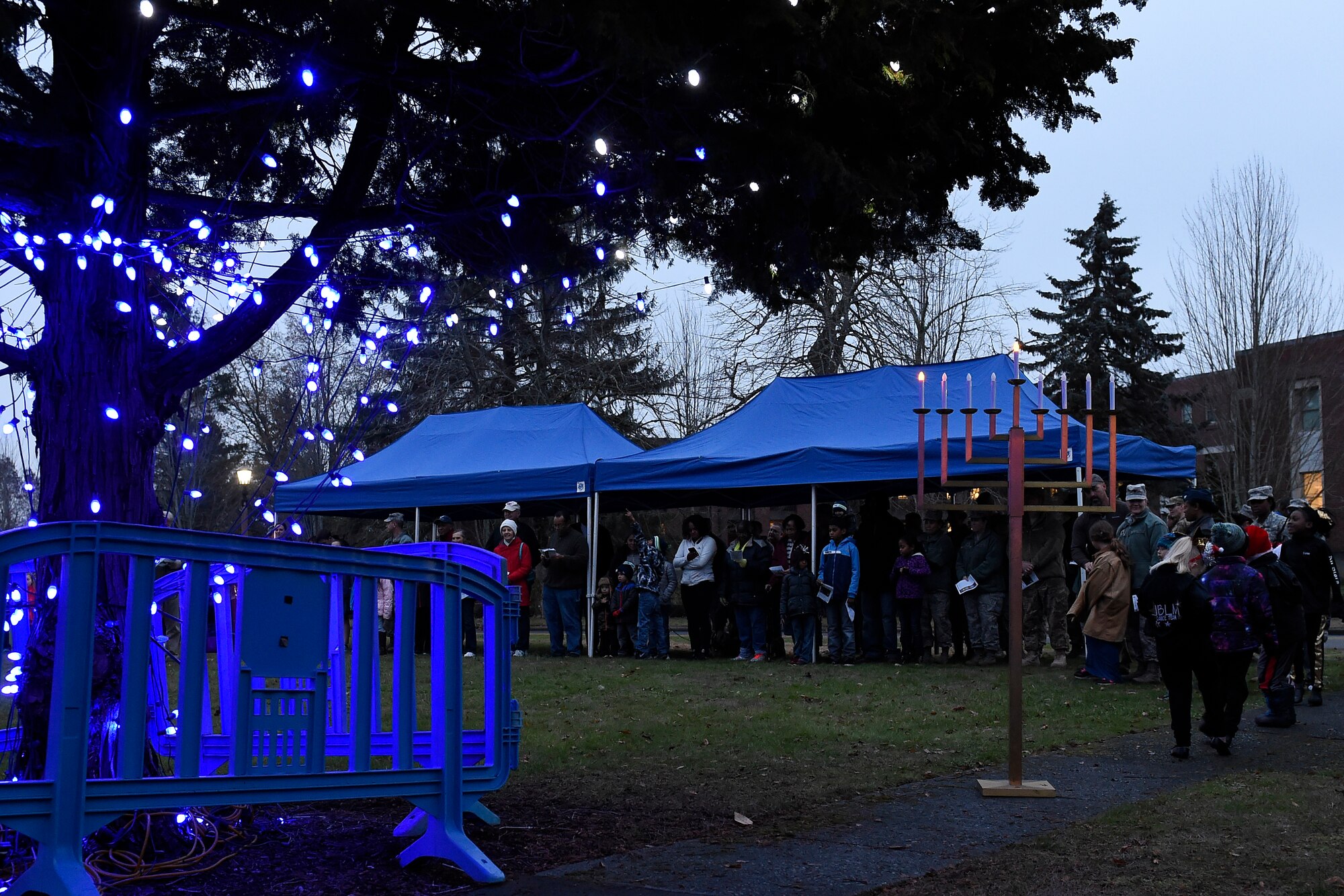 Joint Base Lewis-McChord servicemembers and families gather at the McChord Field Annual Holiday Lighting Ceremony Dec. 2, 2015 at Joint Base Lewis-McChord, Wash. The ceremony had a lighting of a Menorah and a Christmas tree as well as a visit from Santa. (U.S. Air Force photo by Tech. Sgt. Tim Chacon)