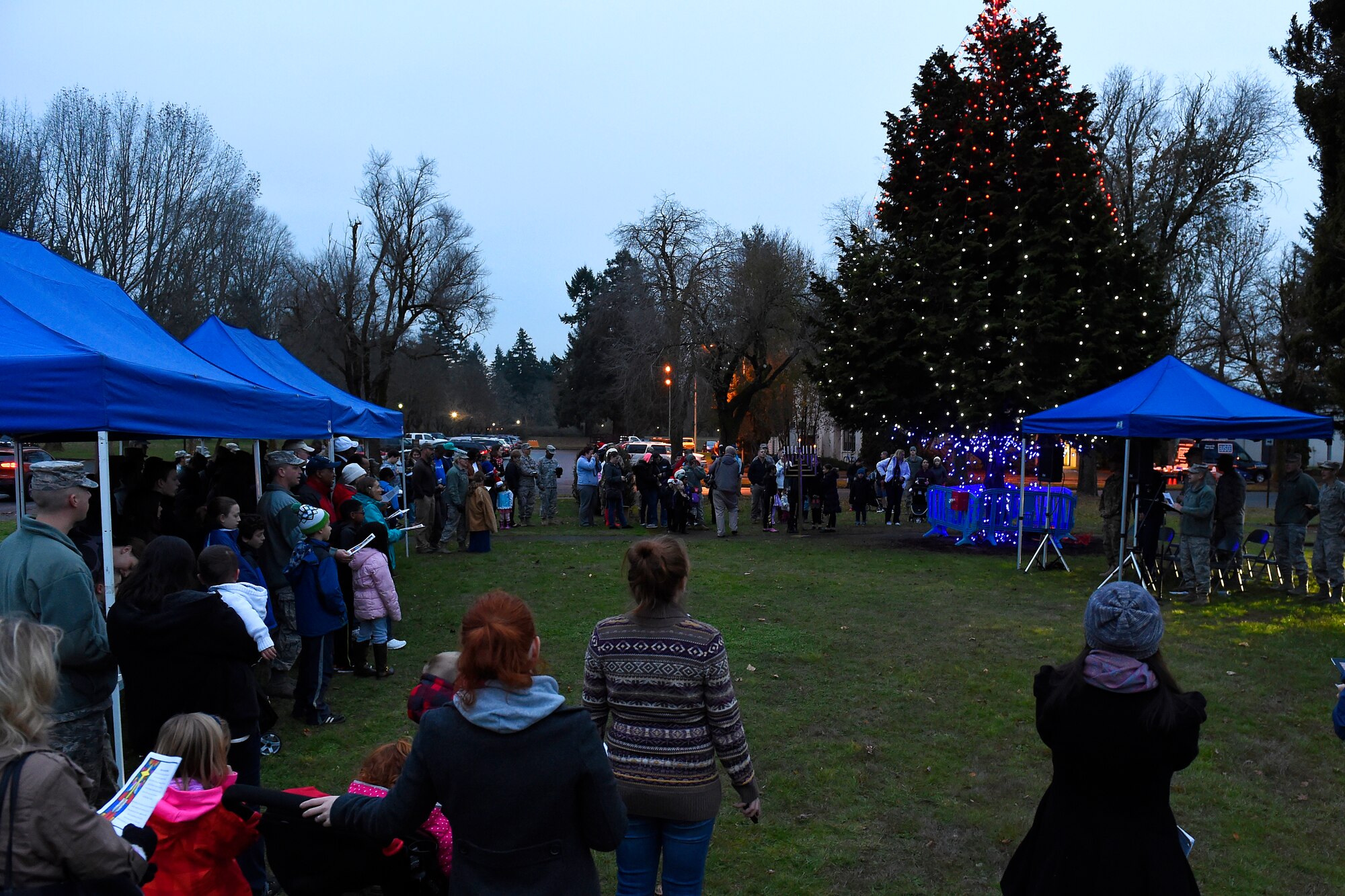 Joint Base Lewis-McChord servicemembers and families gather at the McChord Field Annual Holiday Lighting Ceremony Dec. 2, 2015 at Joint Base Lewis-McChord, Wash. The ceremony had a lighting of a Menorah and a Christmas tree as well as a visit from Santa. (U.S. Air Force photo by Tech. Sgt. Tim Chacon)