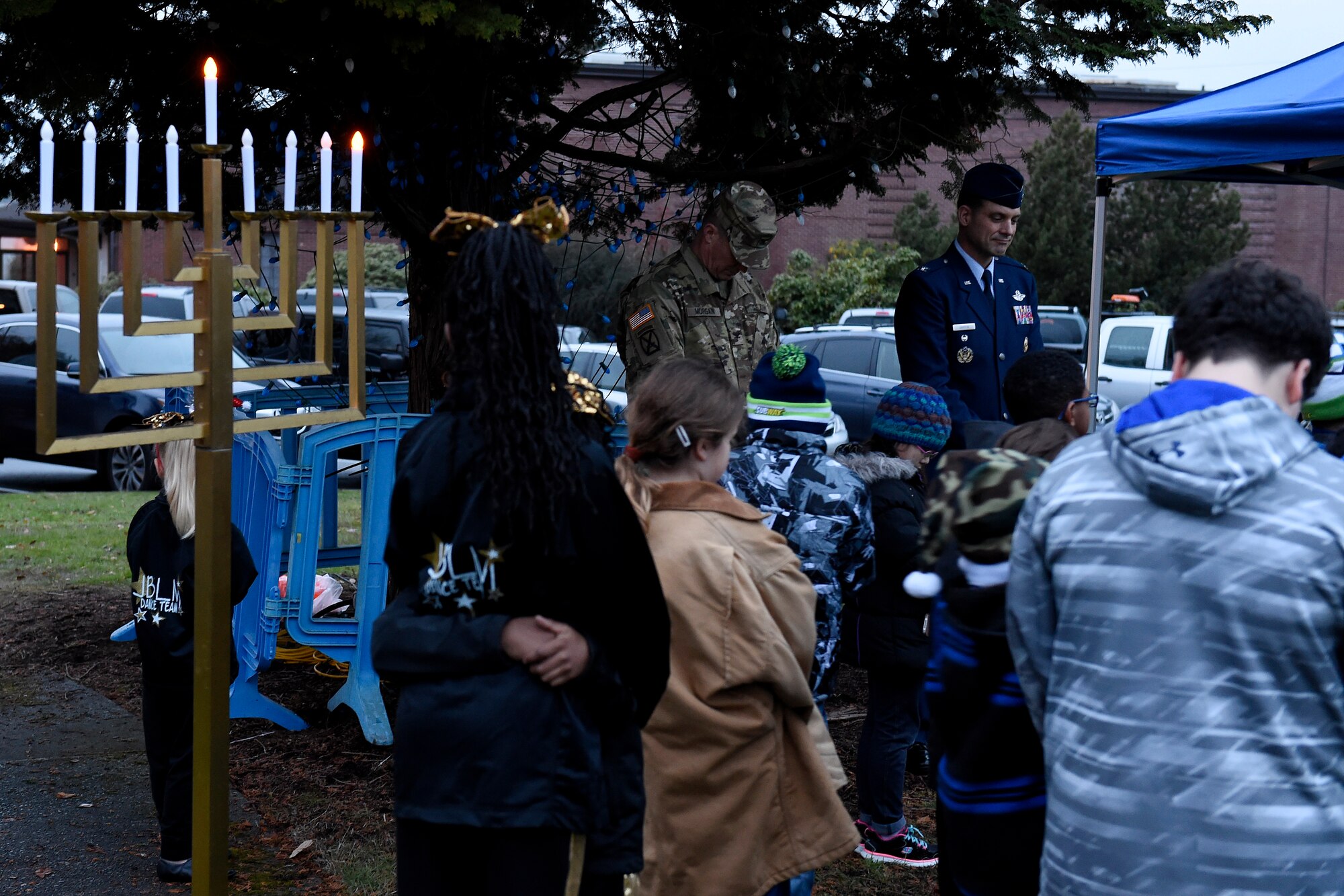 Col. Daniel Morgan, Joint Base Lewis-McChord installation commander (far left) and Col. Ethan Griffin, 62nd Airlift Wing vice commander, take a moment during a prayer at the  holiday lighting the McChord Field Annual Holiday Lighting Ceremony Dec. 2, 2015 at Joint Base Lewis-McChord, Wash. After the prayer, the party “threw the switch” on the McChord field Christmas tree. (U.S. Air Force photo by Tech. Sgt. Tim Chacon)