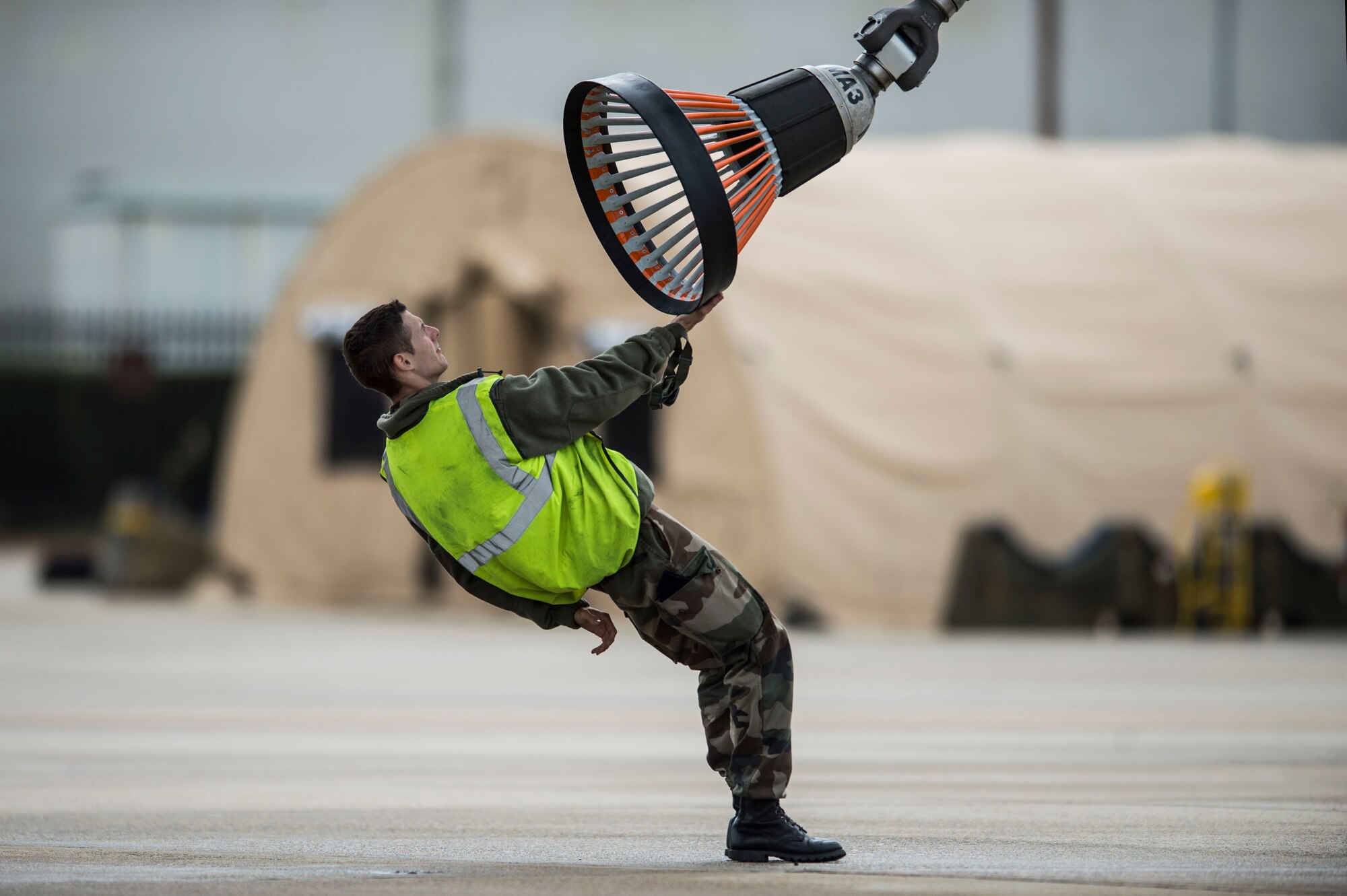 A member of the French Air Force (FrAF) inspects refueling equipment at Langley Air Force Base, Va., Dec. 1, 2015. Approximately 150 personnel from the FrAF arrived at Joint Base Langley-Eustis, Virginia, to participate in a Trilateral Exercise, hosted by the 1st Fighter Wing. (U.S. Air Force photo by Senior Airman Kayla Newman)