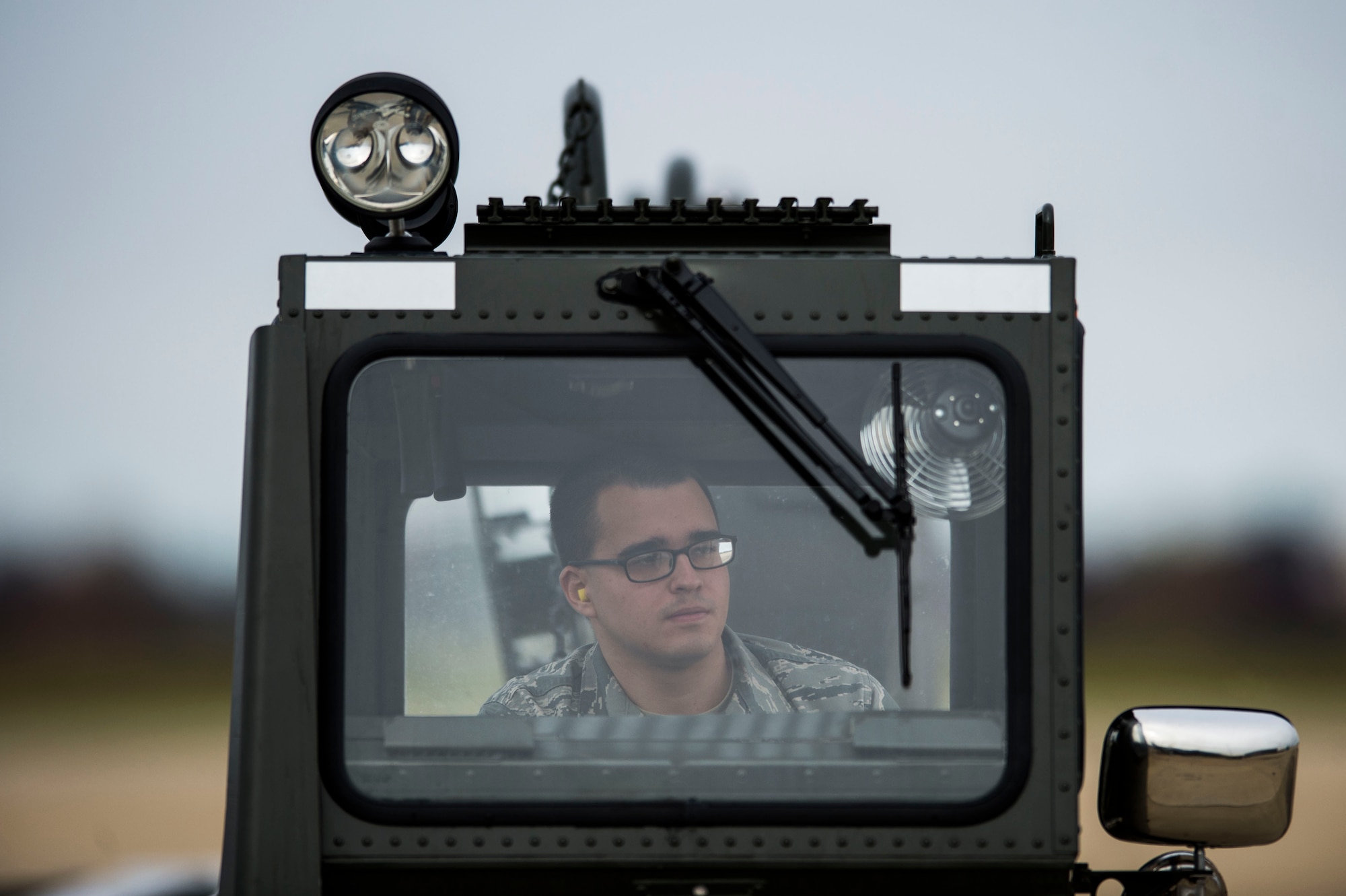 A U.S. Airman awaits permission to unload cargo from a French Air Force (FrAF) aircraft at Langley Air Force Base, Va., Dec. 1, 2015. Multiple FrAF aircraft arrived in preparation for the inaugural Trilateral Exercise between the U.S. Air Force and the British Royal Air Force. (U.S. Air Force photo by Senior Airman Kayla Newman)