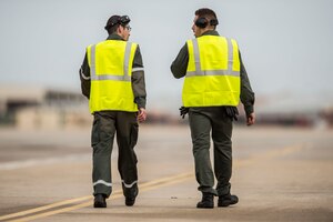 Two French Air Force (FrAF) members walk the flight line at Langley Air Force Base, Va., Dec. 1, 2015. Service members from the U.S. Air Force, British Royal Air Force and FrAF are participating in the inaugural Trilateral Exercise at Joint Base Langley-Eustis, Virginia. (U.S. Air Force photo by Senior Airman Kayla Newman)