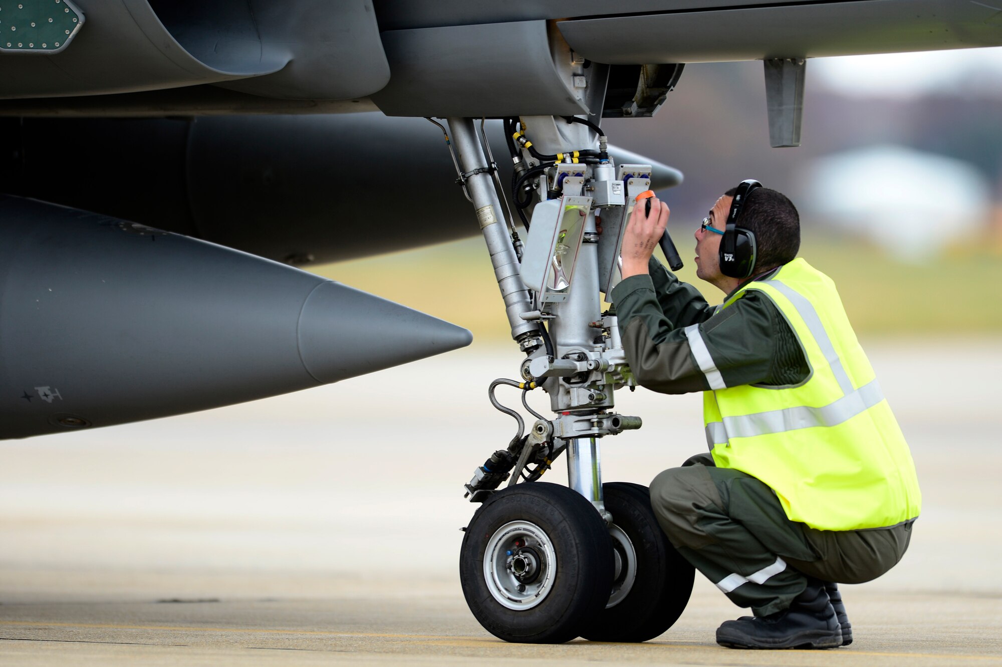 A member of the French Air Force (FrAF) performs post-flight checks on a Dassault Rafale at Langley Air Force Base, Va., Dec. 1, 2015. Along with the Rafale, the British Royal Air Force Eurofighter Typhoon and the U.S. Air Force F-22 Raptor, the U.S. Airborne Warning and Control System and aerial refueling aircraft will participate in the Trilateral Exercise. (U.S. Air Force photo by Senior Airman Kayla Newman)