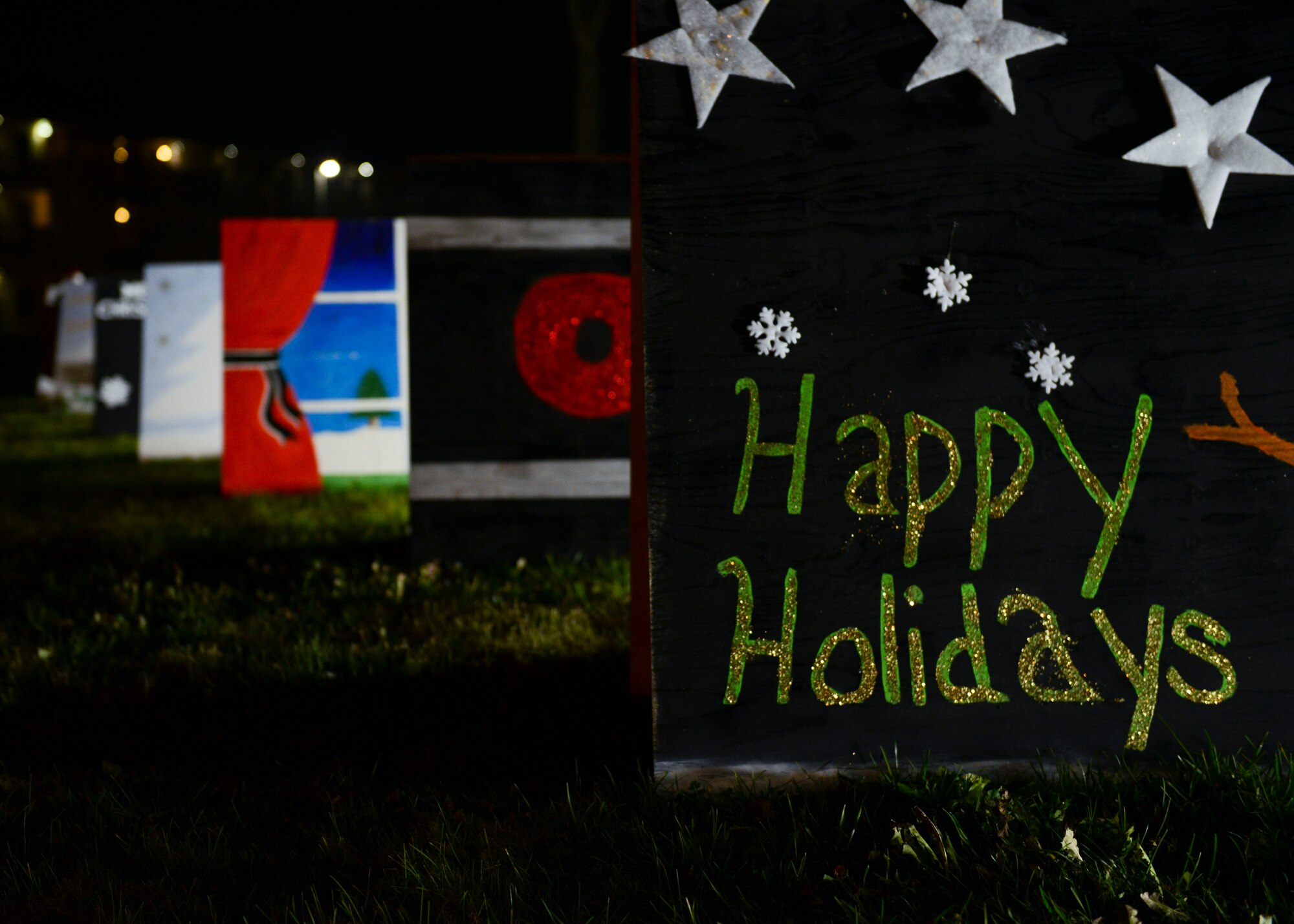 Giant holiday greeting cards line the post office sidewalk to inspire holiday cheer, Dec. 1, 2015, at Aviano Air Base, Italy. The 31st Force Support Squadron took home first in the greeting card competition with AFN and the 31st Security Forces Squadron winning second and third, respectively. (U.S. Air Force photo by Senior Airman Austin Harvill/Released)