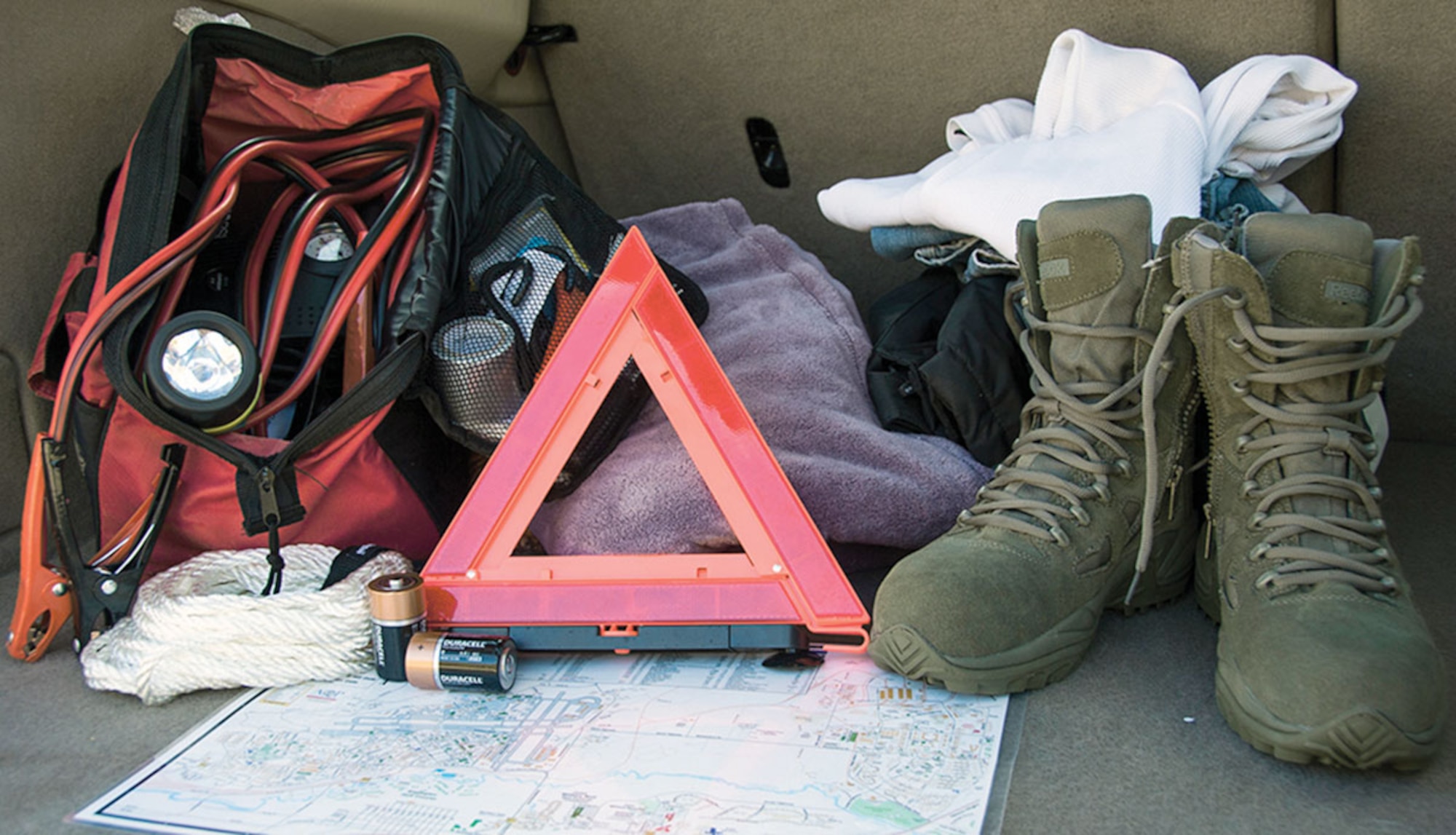 Roadside kits, like the one pictured above, should contain jumper cables, a flashlight, first aid kit, fluorescent distress signal and battery charger. Emergency preparedness kits should be included in everyday travel at any time of the year. During the winter months, kits should include an extra set of warm clothing, winter boots, socks, cold weather jacket and coveralls, water, snacks, and sand. (U.S. Air Force photo/Senior Airman Tammie Ramsouer)