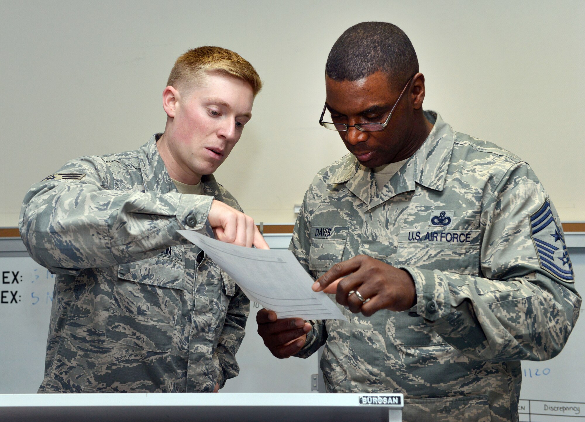 Senior Airman Connor Carson, 39th Security Forces Squadron, briefs Chief Master Sgt. James Davis, U.S. Air Forces in Europe and Air Forces Africa command chief, during a base visit Dec. 1, 2015, at Incirlik Air Base, Turkey. During the visit, Davis met with deployers, toured key facilities and had lunch with Airmen stationed at Incirlik AB. (U.S. Air Force photo by Staff Sgt. Michael Battles/Released)