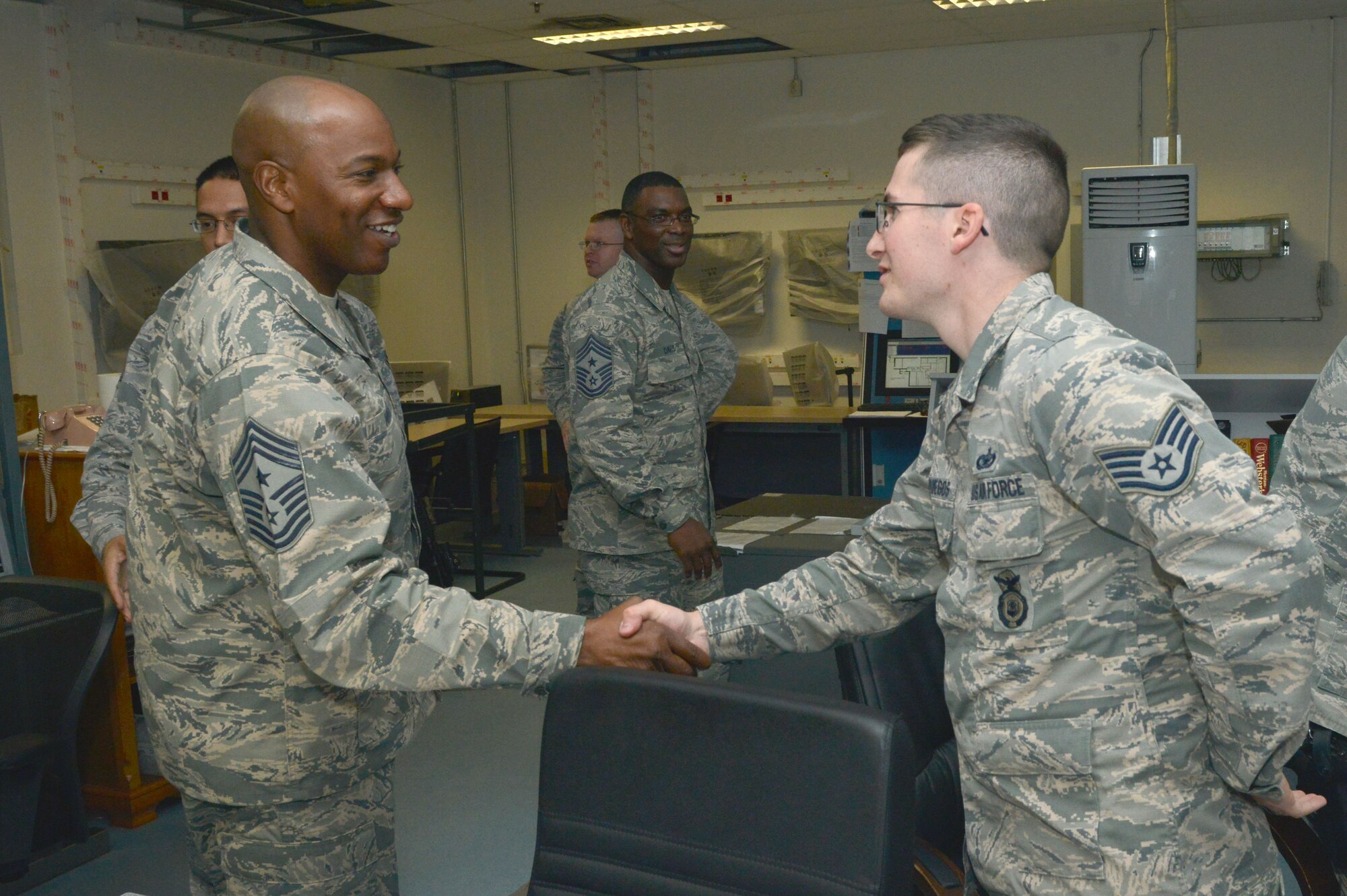Chief Master Sgt. Kaleth Wright, 3rd Air Force command chief, greets a 39th Security Forces Squadron defender during a base visit Dec. 1, 2015, at Incirlik Air Base, Turkey. During the visit, Wright met with deployers, toured key facilities and had lunch with Airmen, both deployed and stationed at Incirlik AB.  (U.S. Air Force photo by Staff Sgt. Michael Battles/Released)
