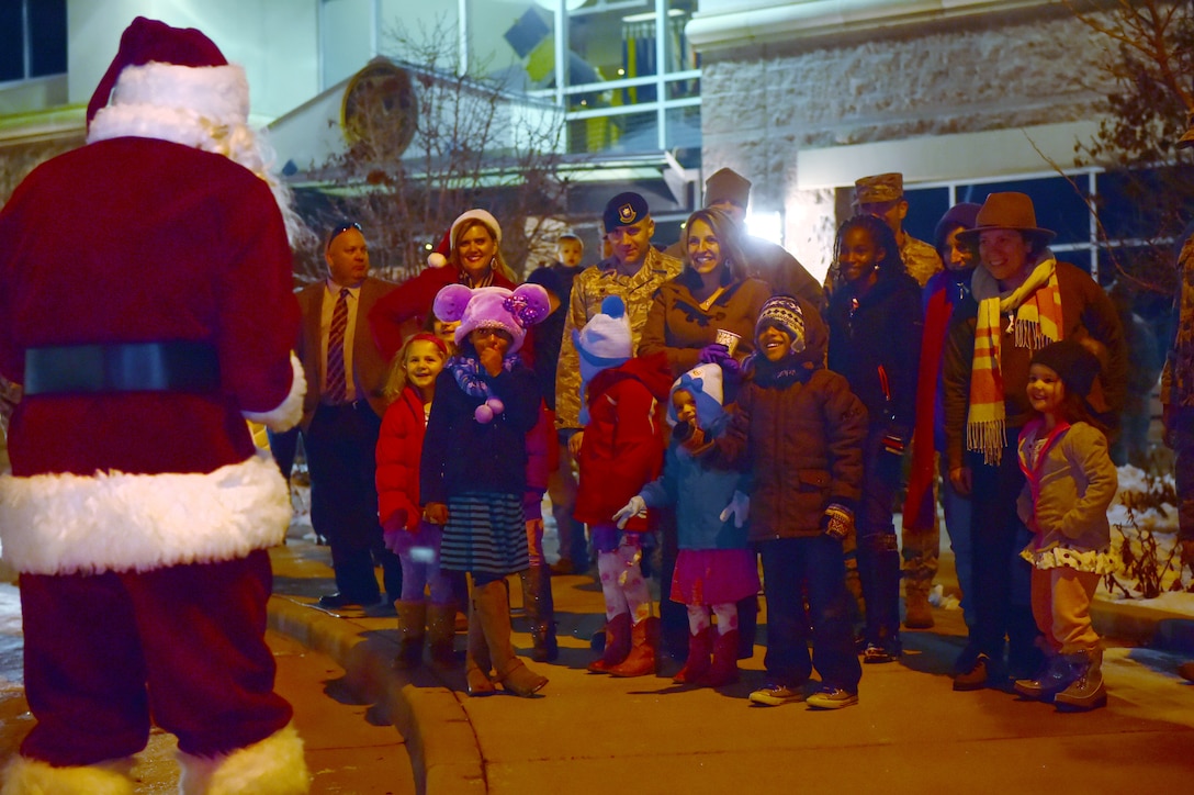 Santa Claus hands out candy canes to children Dec. 2, 2015, on Buckley Air Force Base, Colo. Members of Team Buckley gathered for the annual tree-lighting ceremony which included carolers, refreshments and Santa Claus to celebrate the holiday season. (U.S. Air Force photo by Airman 1st Class Luke W. Nowakowski/Released)