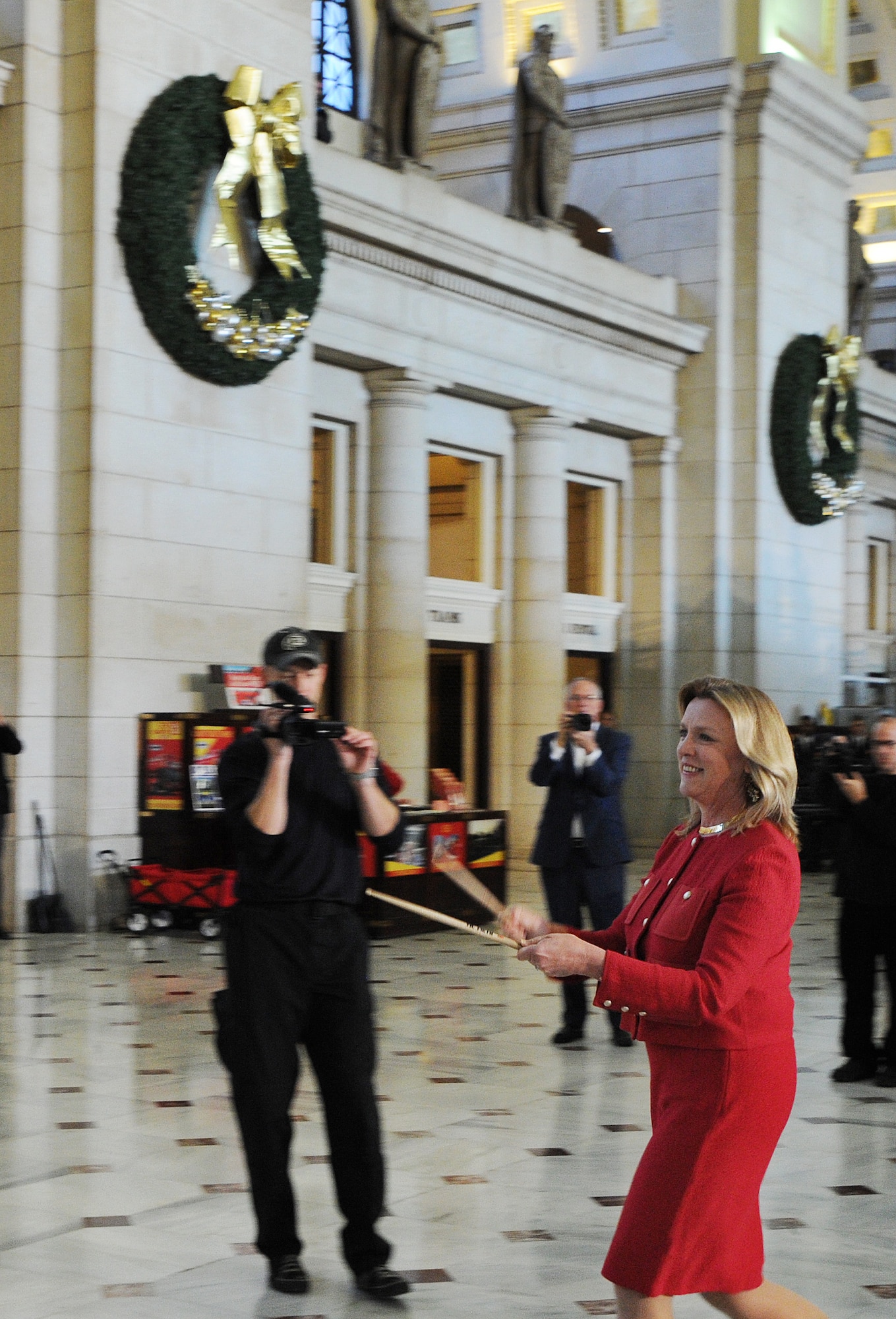 Secretary of the Air Force Deborah Lee James signals the beginning of an impromptu concert at Union Station by handing a pair of drumsticks to a solo drummer from the U.S. Air Force Band’s Airmen of Note. The United States Air Force Band surprised commuters at Union Station with a World War II Holiday Flashback Dec. 3, 2015. The event was designed to be a special holiday musical presentation celebrating the service and sacrifices of our nation’s World War II veterans.