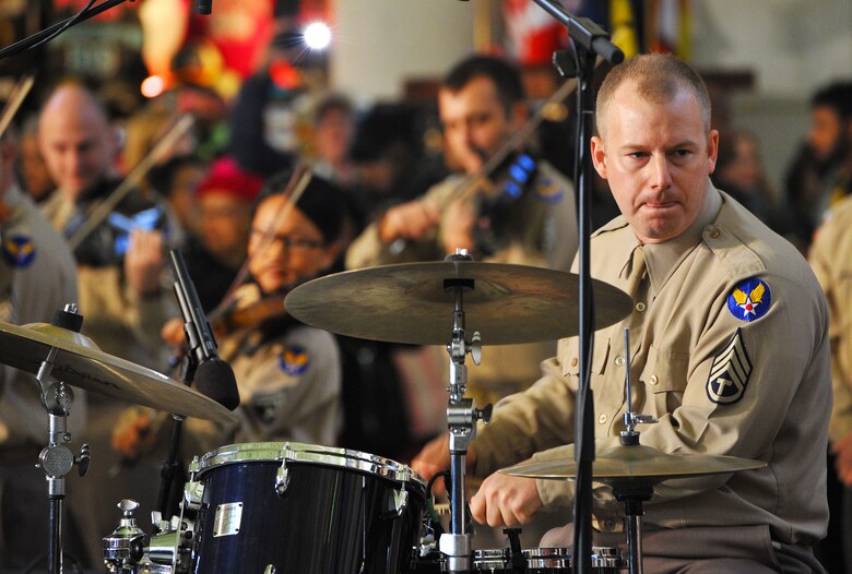 Technical Sgt. David MacDonald, a drummer for the U.S. Air Force Band’s Airmen of Note, performs for an impromptu crown at Union Station. The United States Air Force Band surprised commuters at Union Station with a World War II Holiday Flashback Dec. 3, 2015. The event was designed to be a special holiday musical presentation celebrating the service and sacrifices of our nation’s World War II veterans.