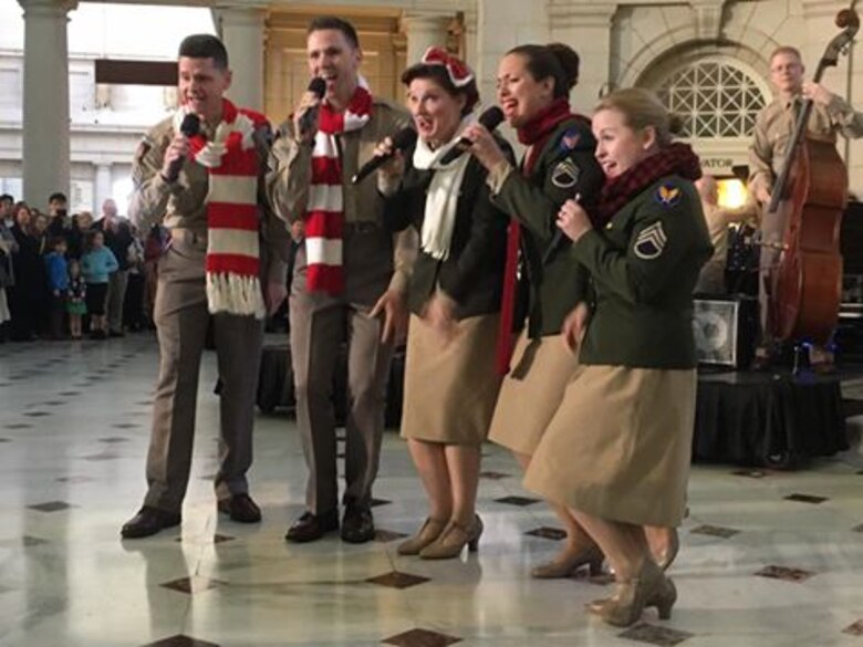 Members of the U.S. Air Force Band's Singing Sergeants perform for an impromptu crown at Union Station. The United States Air Force Band surprised commuters at Union Station with a World War II Holiday Flashback Dec. 3, 2015. The event was designed to be a special holiday musical presentation celebrating the service and sacrifices of our nation’s World War II veterans.