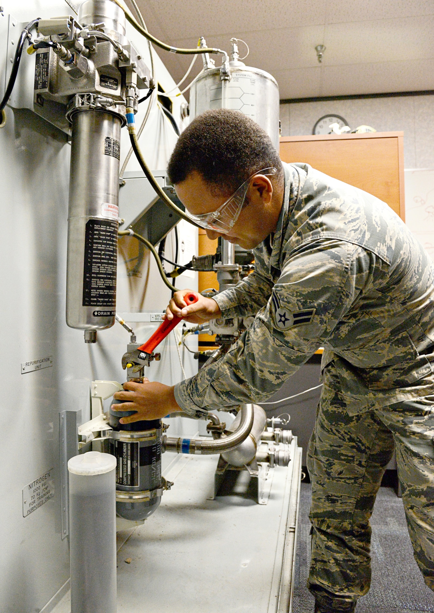 Airman 1st Class Toris Richardson services a liquid cooling system on one of the training modules at the 373rd Training Reserve Squadron. (Air Force photo by Kelly White/Released)