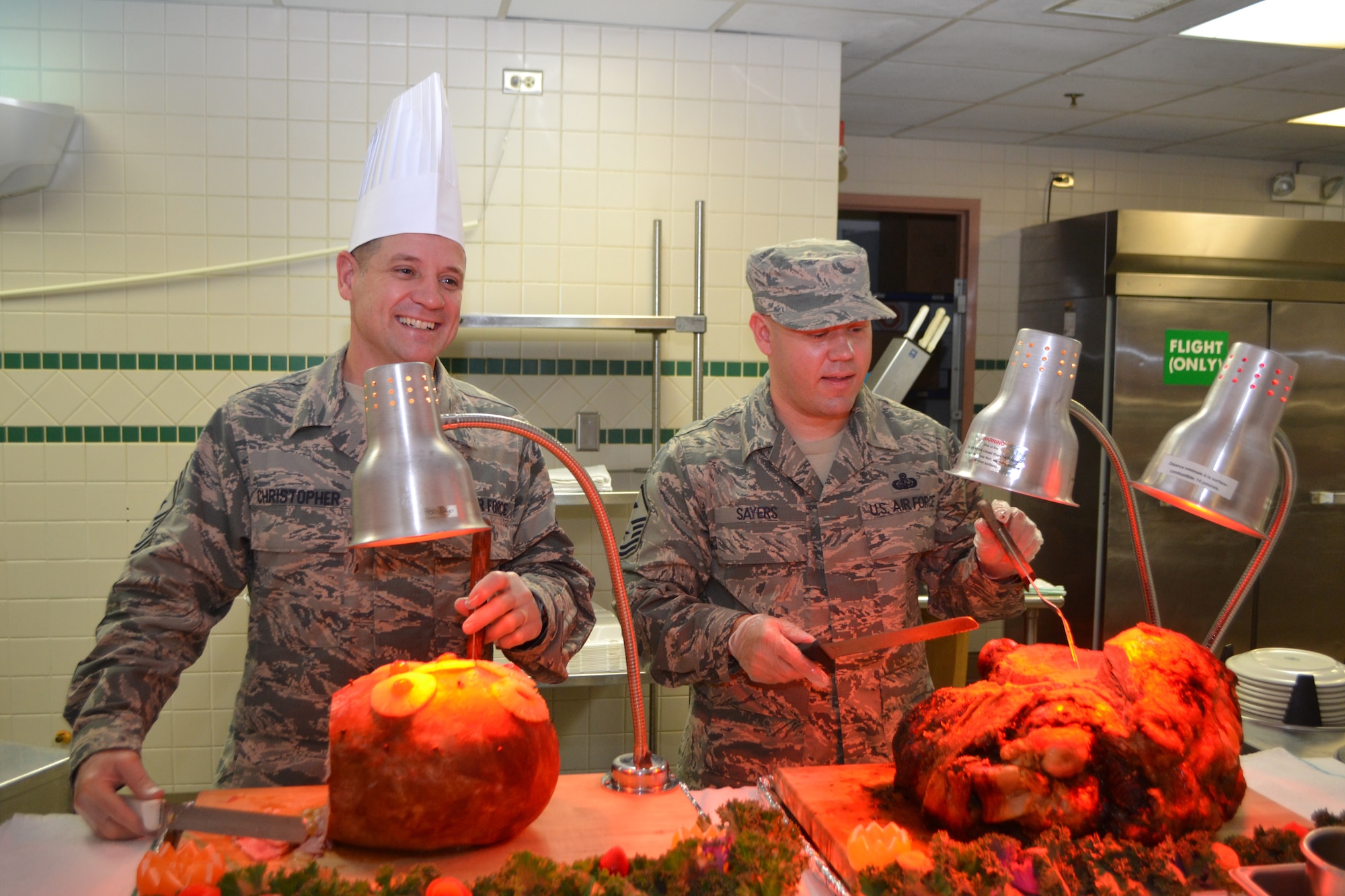 72nd Air Base Wing Command Chief Master Sgt. Thomas Christopher and Master Sgt. Anthony Sayers, 960th Airborne Air Control Squadron first sergeant, prepare to serve guests. (Air Force photo by Ron Mullan/Released)

