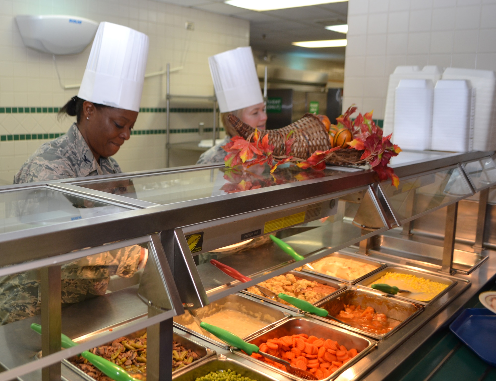 Col. Stephanie Wilson, 72nd Air Base Wing commander, left, and Col. Lea Kirkwood, 72nd ABW vice commander, man the serving line at the Vanwey Dining Facility on Thanksgiving. (Air Force photo by Ron Mullan/Released)

