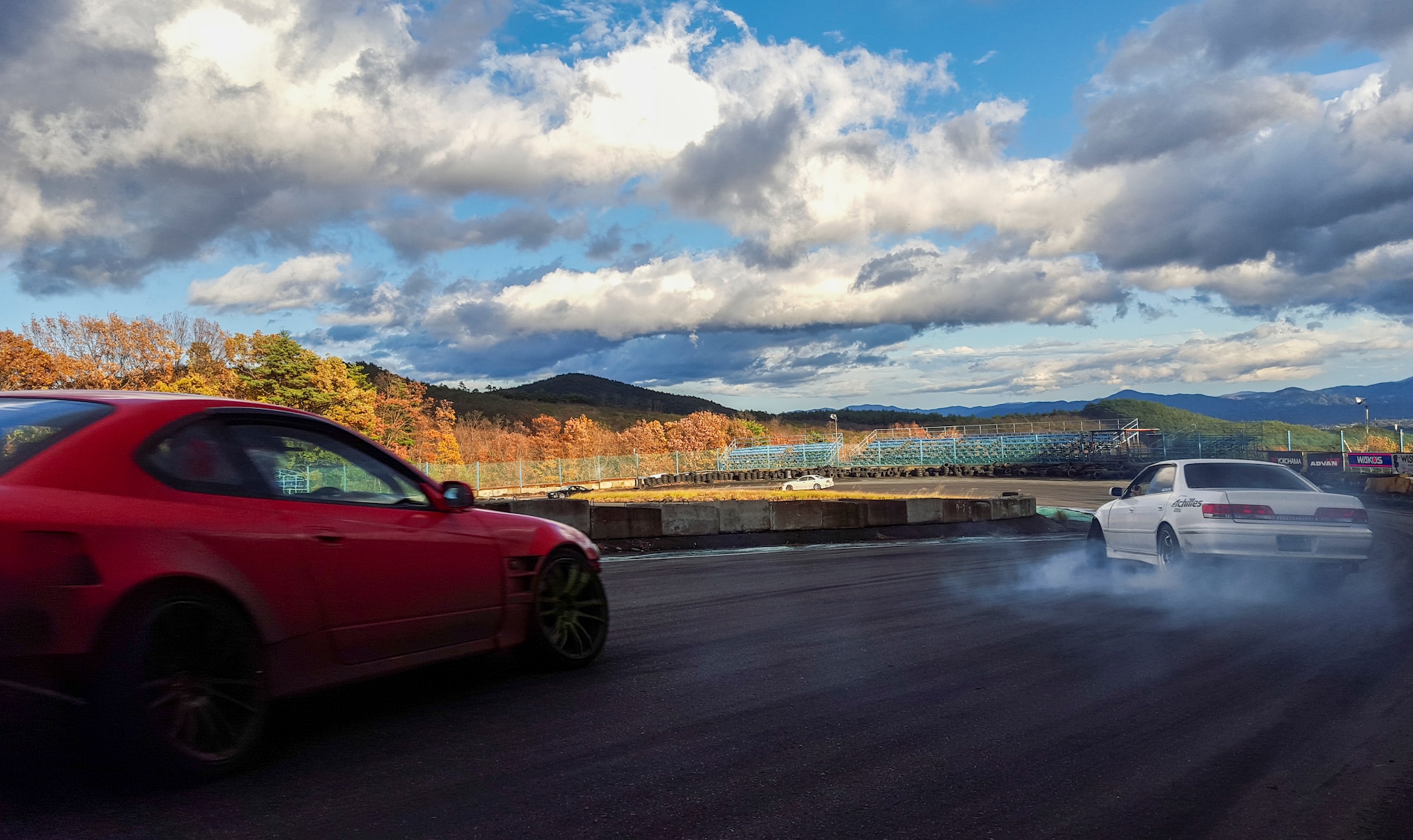Participants in the Ebisu Circuit fall drift festival compete on Minami course at Ebisu Circuit, Japan, Nov. 15, 2015. Drifting is a popular sport originating in Japan as a method of turning corners on mountain roads. For safety, a roll cage reinforces the structure of the car, wide margins clear the way for spinouts and helmets and seatbelts are always required. (U.S. Air Force photo by Airman 1st Class Elizabeth Baker/Released)