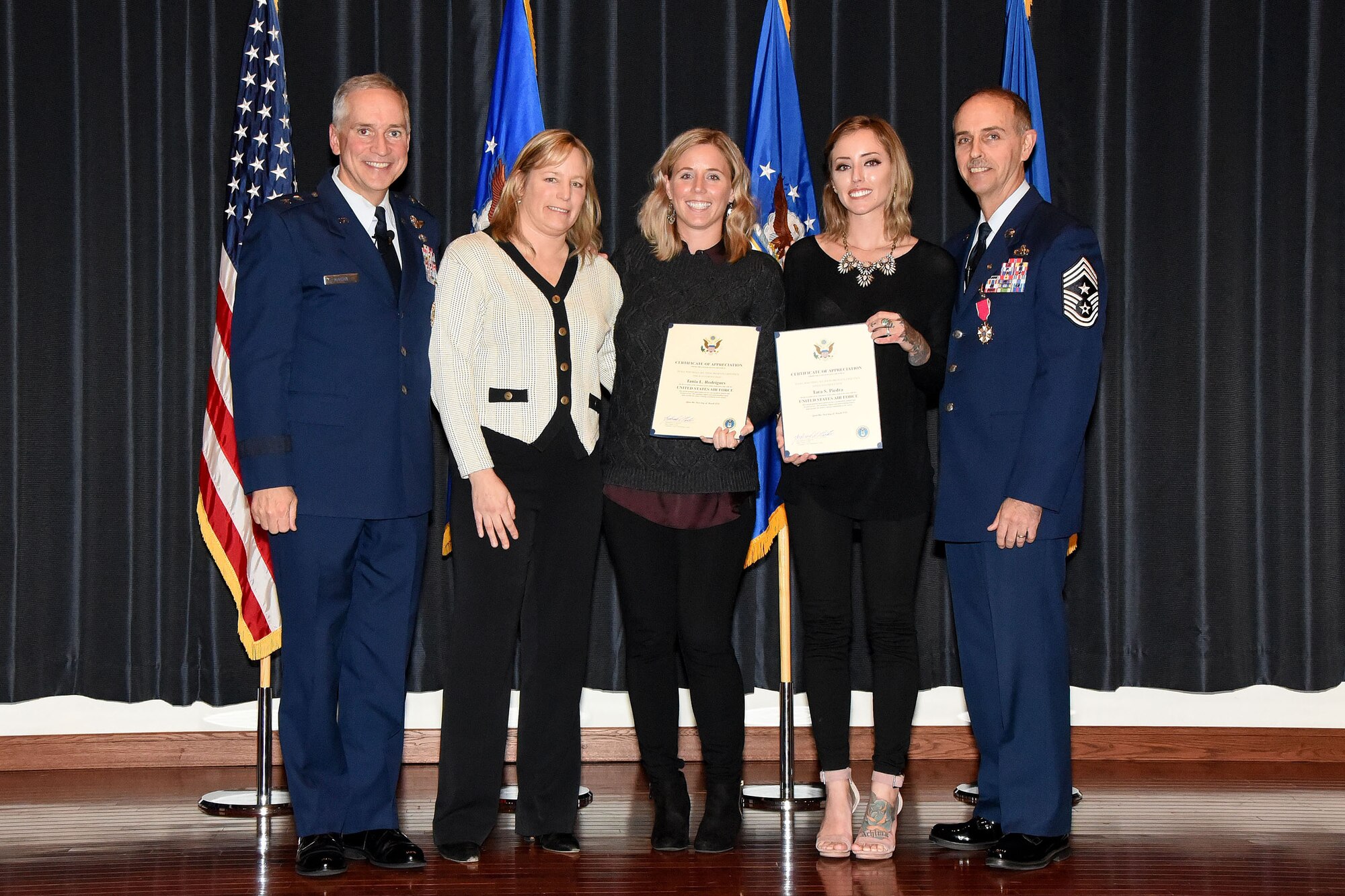 Chief Master Sgt. Pete Stone(right), poses with his wife, their two daughters, and Maj. Gen. Rick Martin, U.S. Air Force Expeditionary Center commander, during Stone's retirement ceremony Nov. 30., at Joint Base McGuire-Dix-Lakehurst, N.J. Stone, who's final position was as the USAF EC command chief, retires after serving 30 years on active duty.(U.S. Air Force photo/Danielle Brooks)